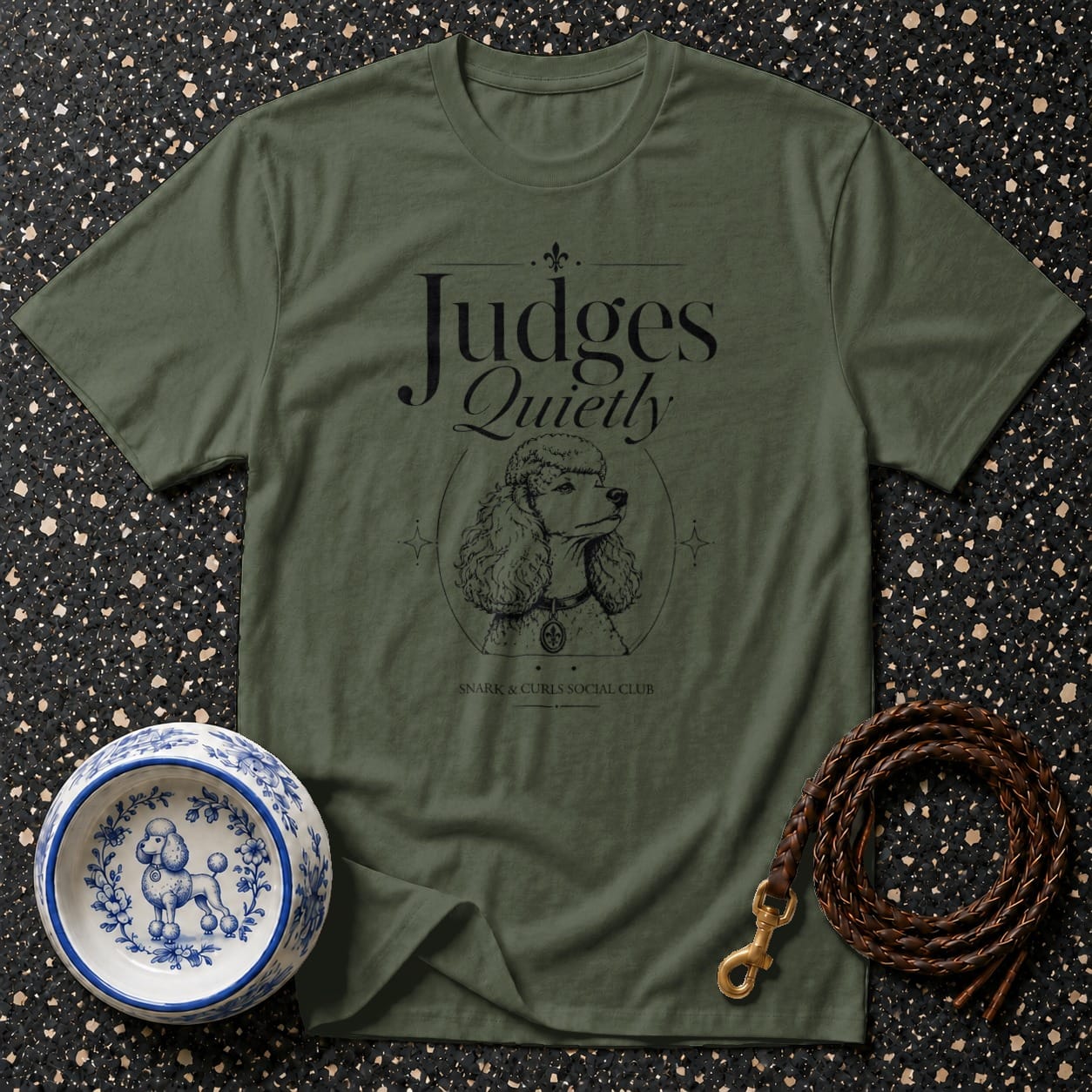 Olive green t-shirt with a poodle graphic and "Judges Quietly" text.
