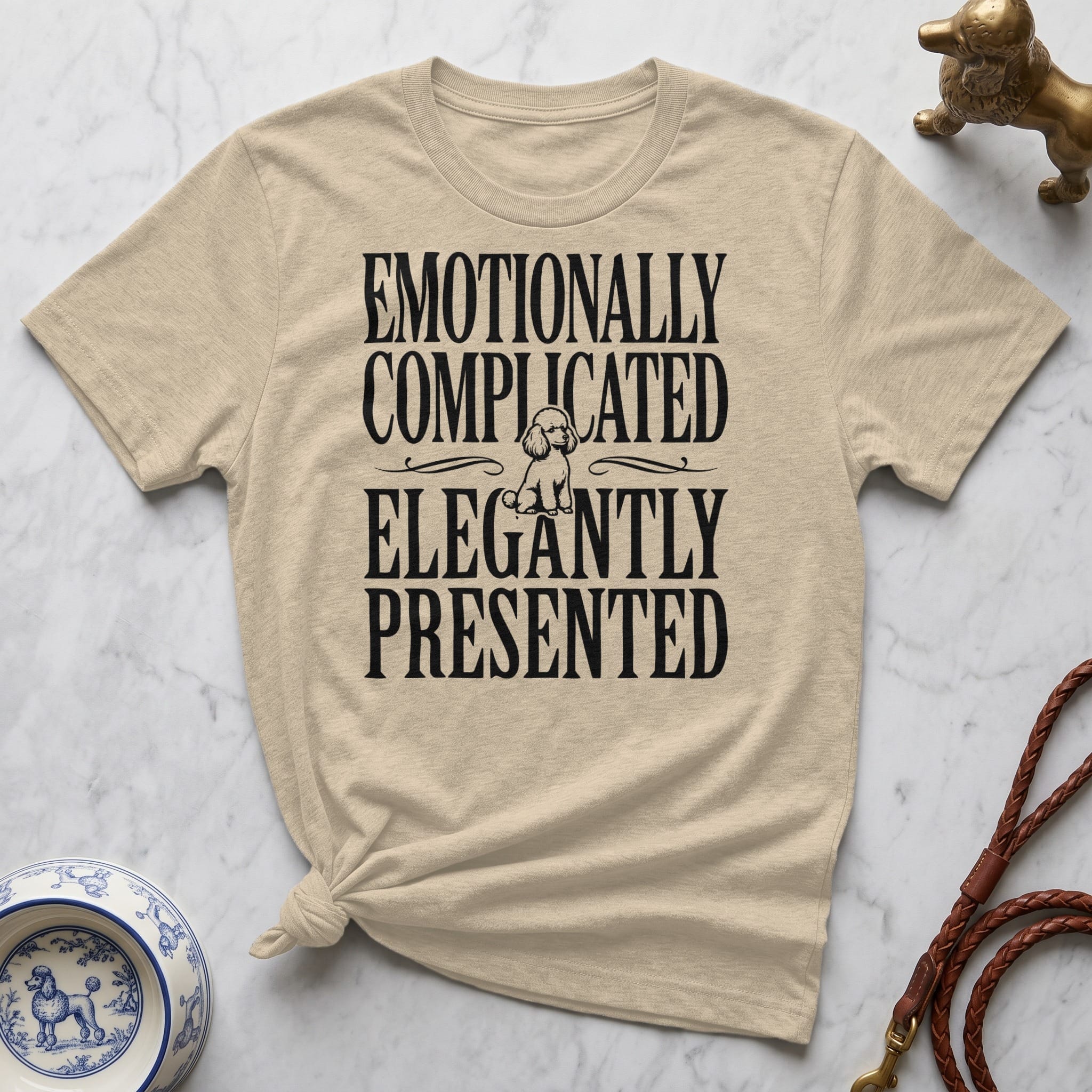 Cream t-shirt with "Emotionally Complicated Elegantly Presented" text and poodle graphic.