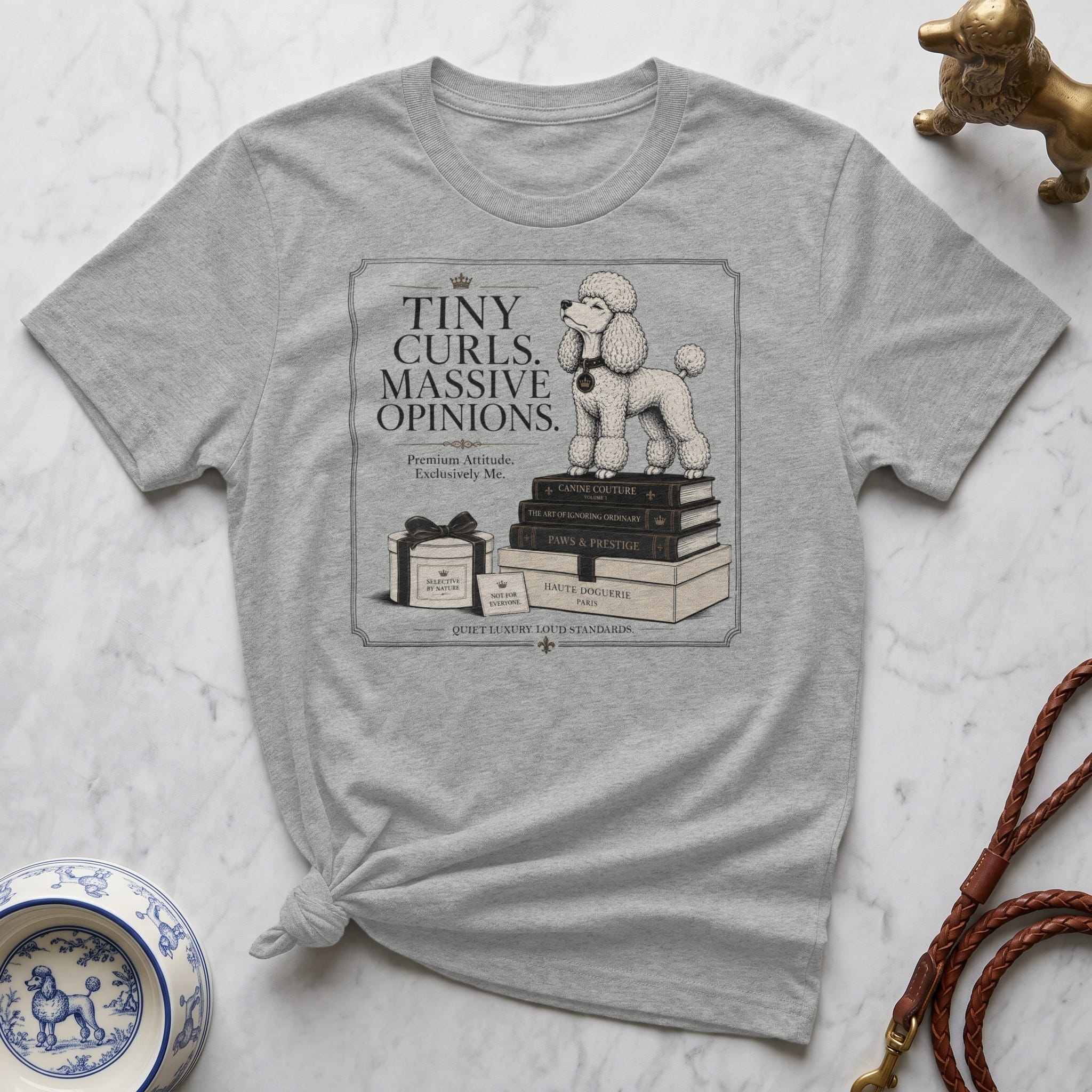 T-shirt with a poodle on stacked books, featuring text about "Tiny Curls. Massive Opinions."
