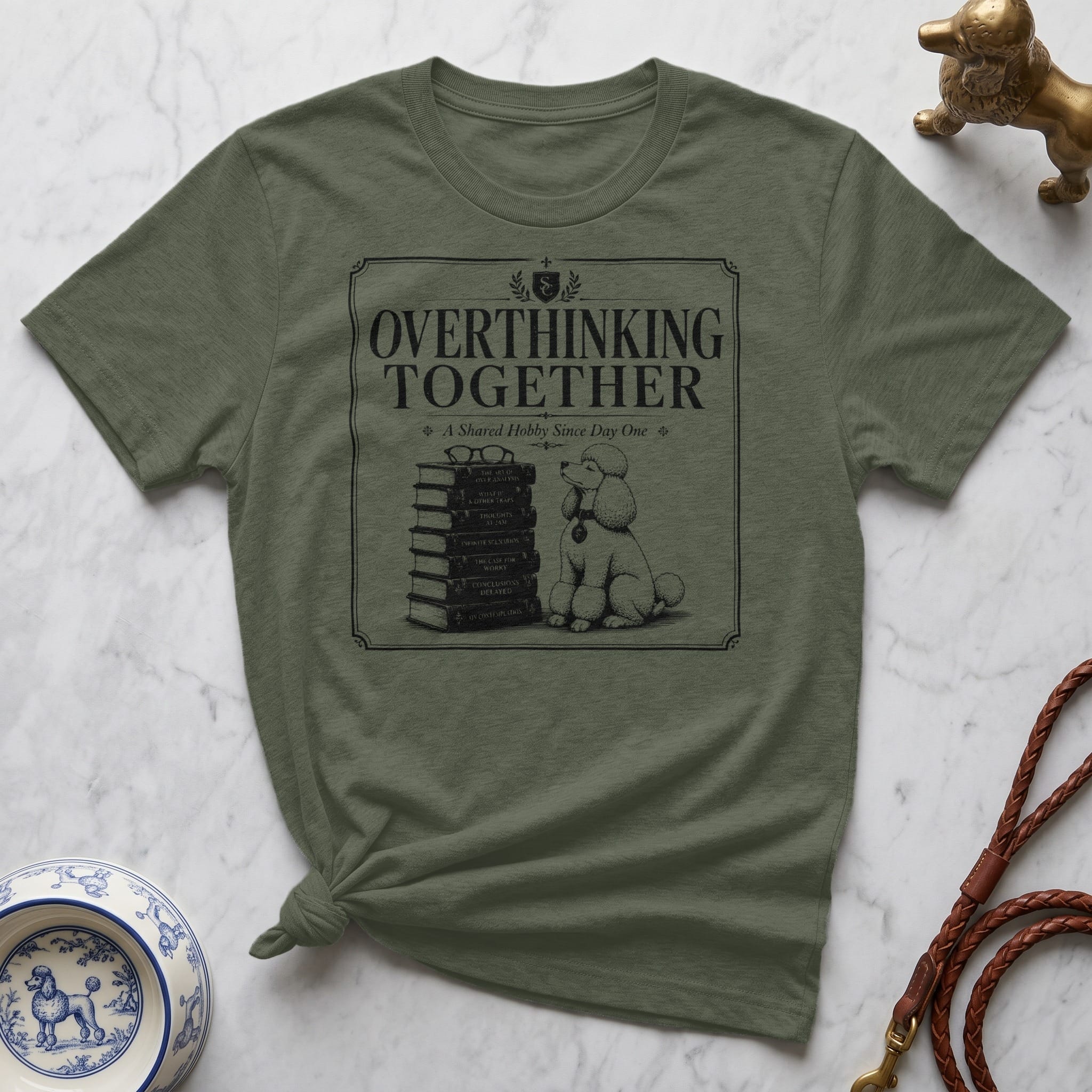 Green t-shirt with "Overthinking Together" text and a poodle with stacked books.