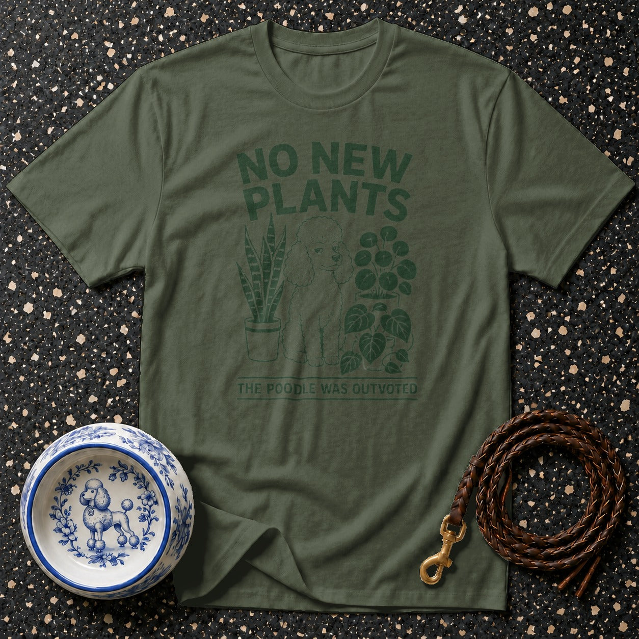 Olive green t-shirt with "No New Plants The Poodle Was Outvoted" text and poodle graphic.