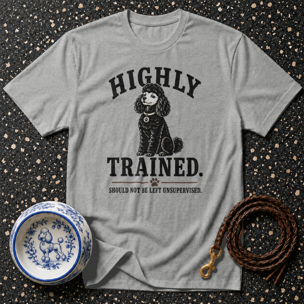 Grey t-shirt with "HIGHLY TRAINED. SHOULD NOT BE LEFT UNSUPERVISED." text and poodle graphic.