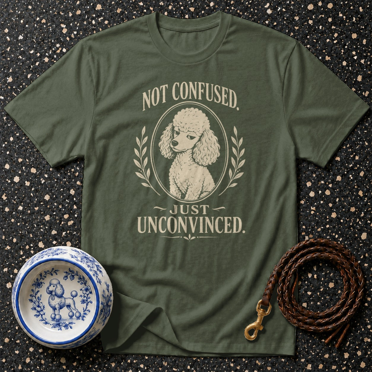 Green t-shirt with a poodle graphic and text "NOT CONFUSED, JUST UNCONVINCED."