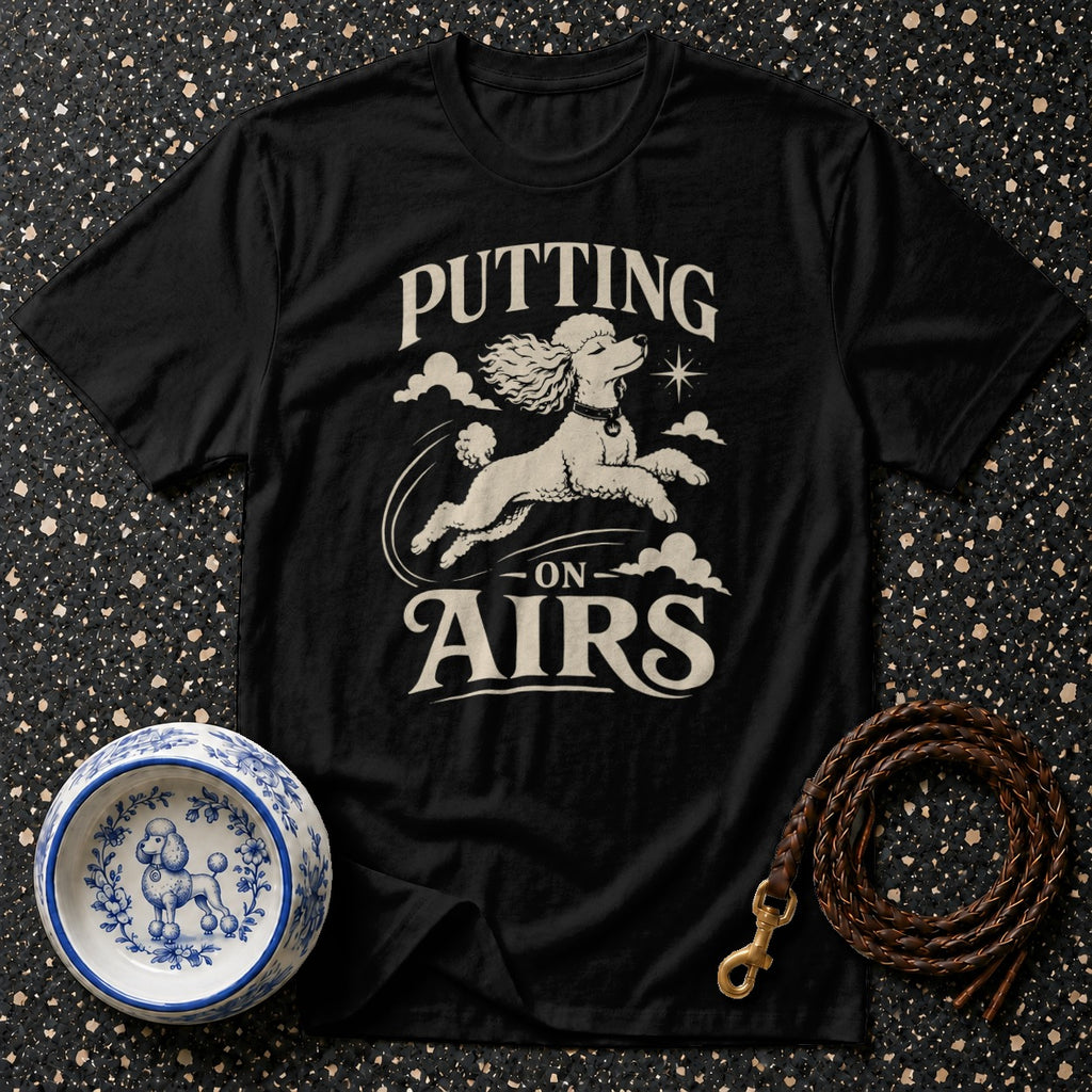 Black t-shirt with white poodle graphic and "Putting On Airs" text.