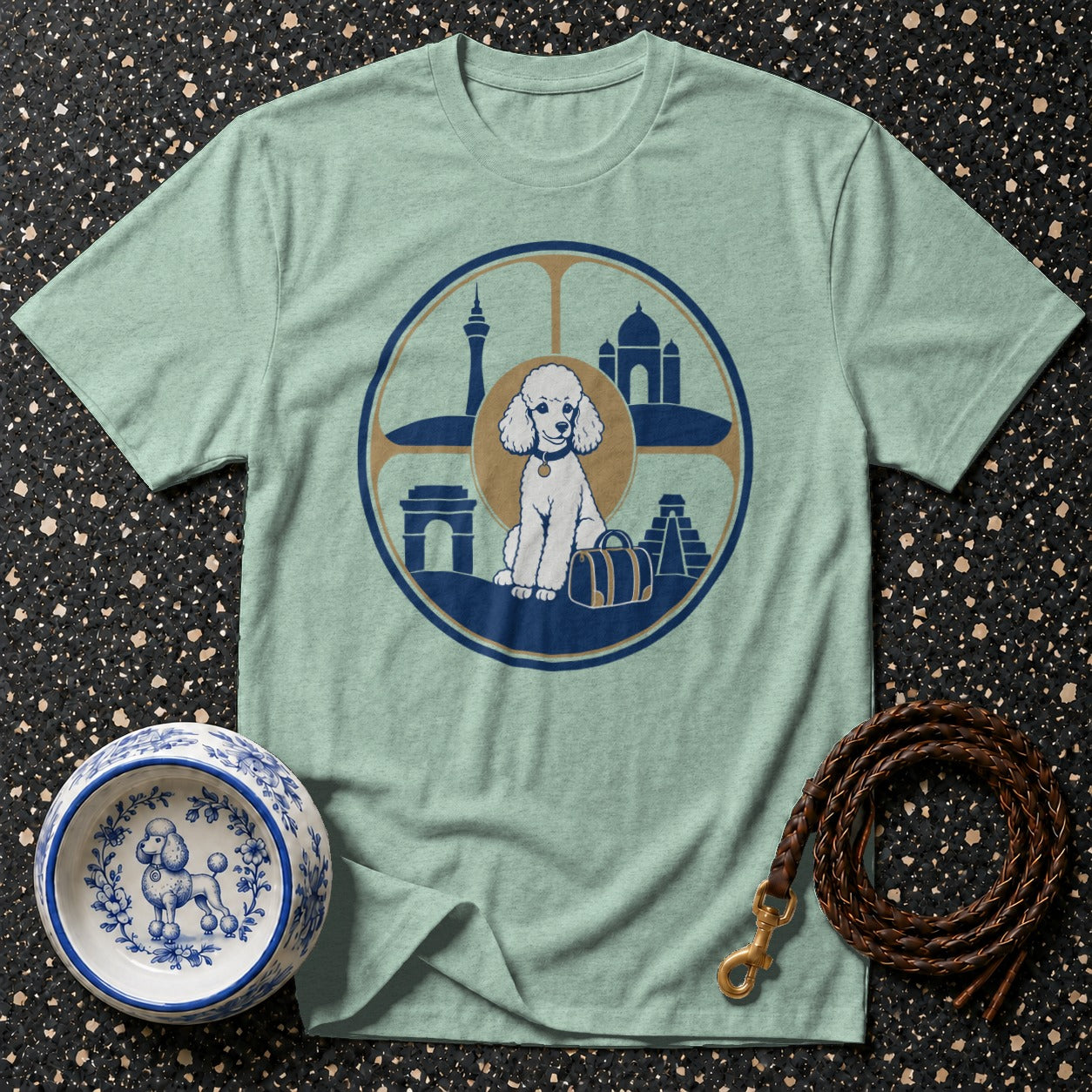 Pale blue t-shirt with graphic of a white poodle surrounded by world landmarks.