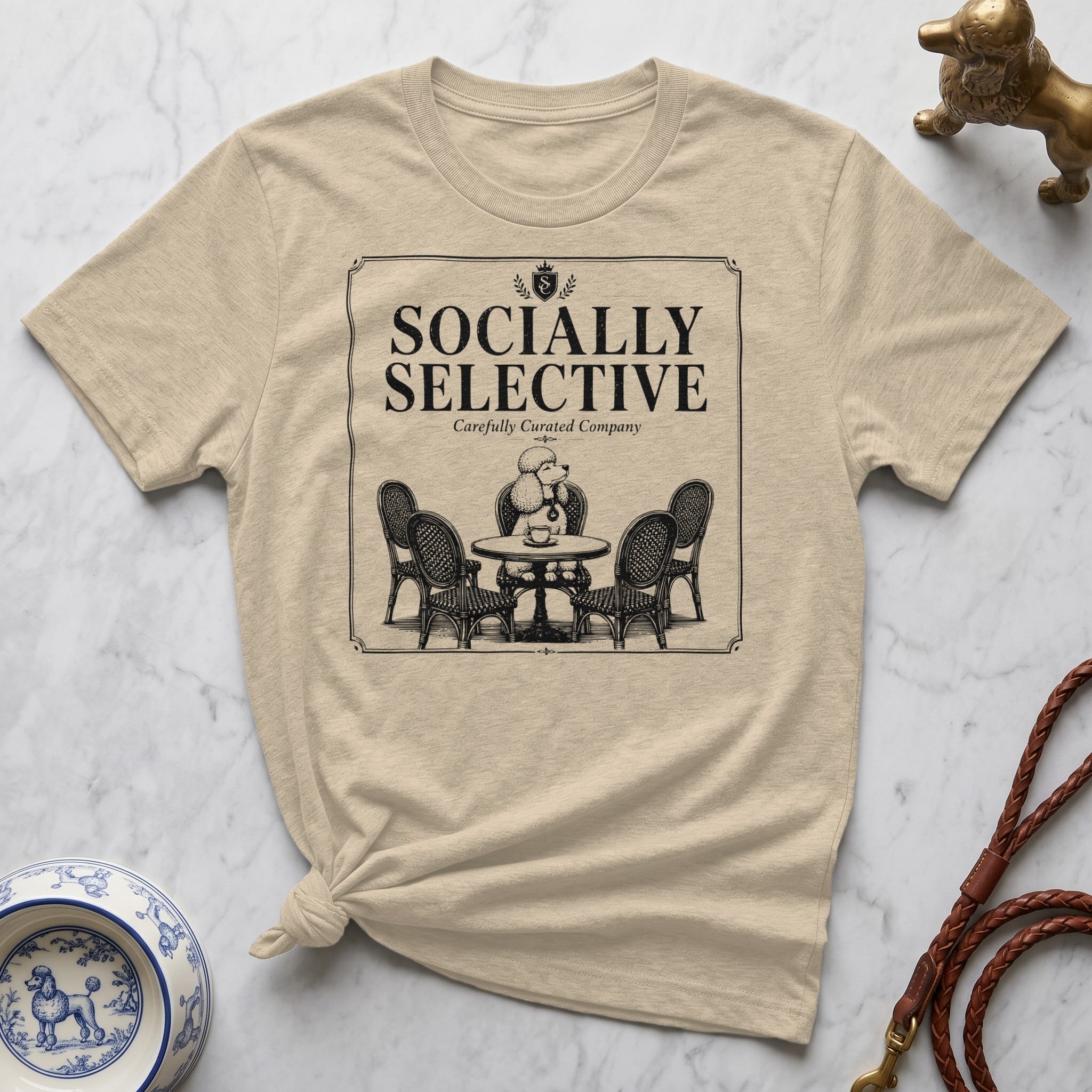 Cream t-shirt with "Socially Selective" and dog cafe illustration.