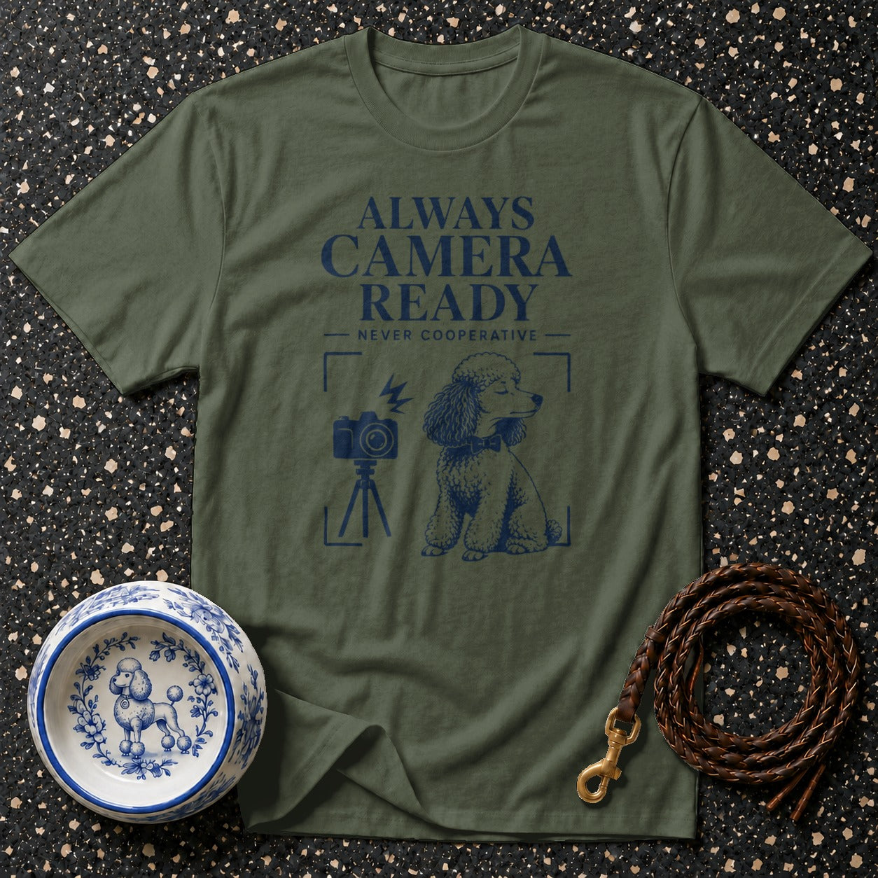 Olive green t-shirt with navy blue poodle, camera, and text design.