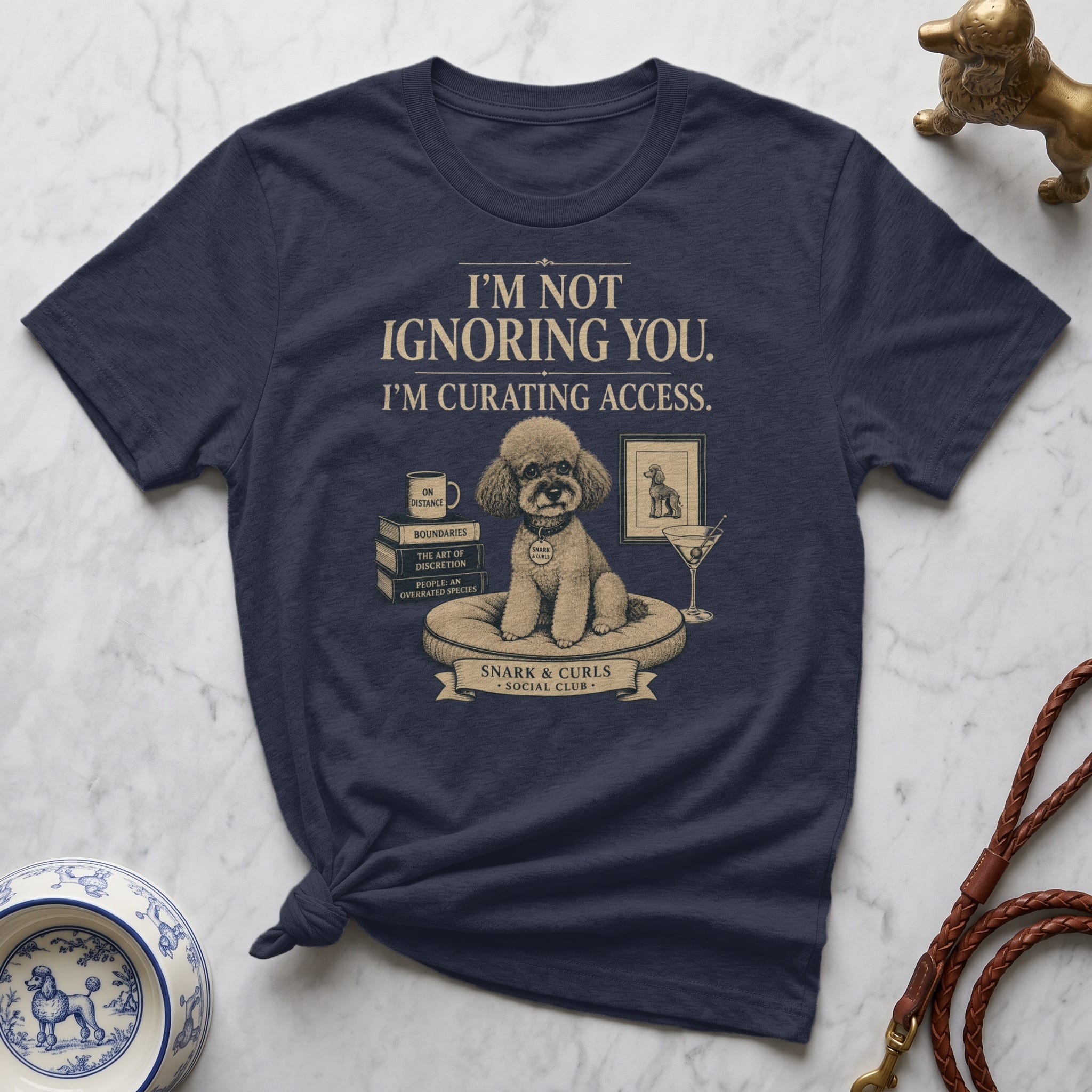 Navy t-shirt with poodle illustration and text "I'M NOT IGNORING YOU. I'M CURATING ACCESS."