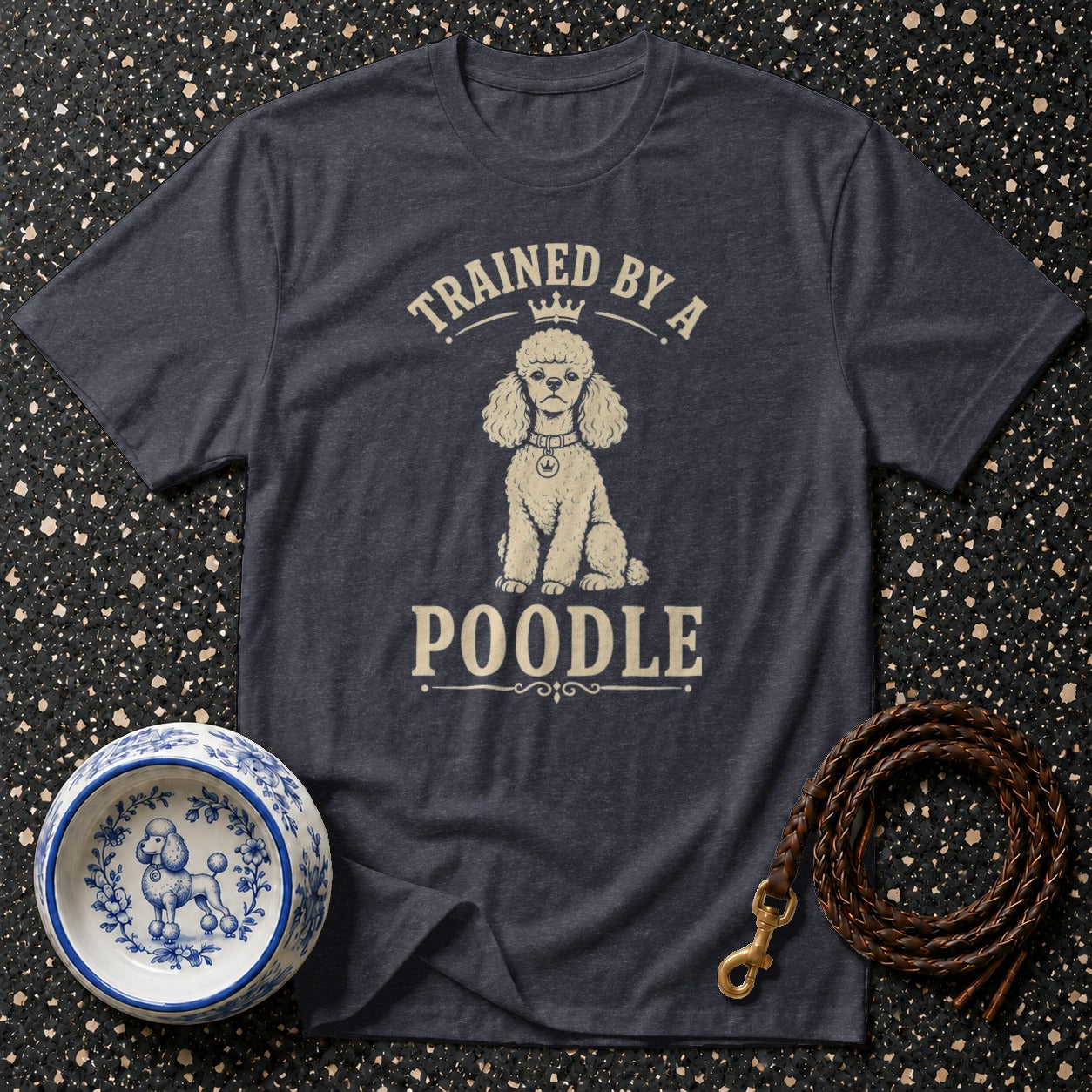 Dark grey t-shirt with a poodle design and text "TRAINED BY A POODLE".