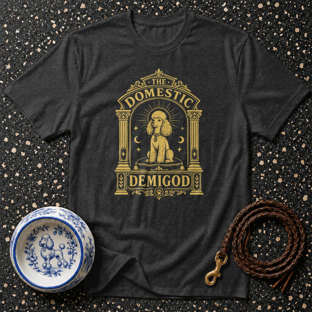 Dark t-shirt with gold graphic reading "The Domestic Demigod" featuring a poodle.