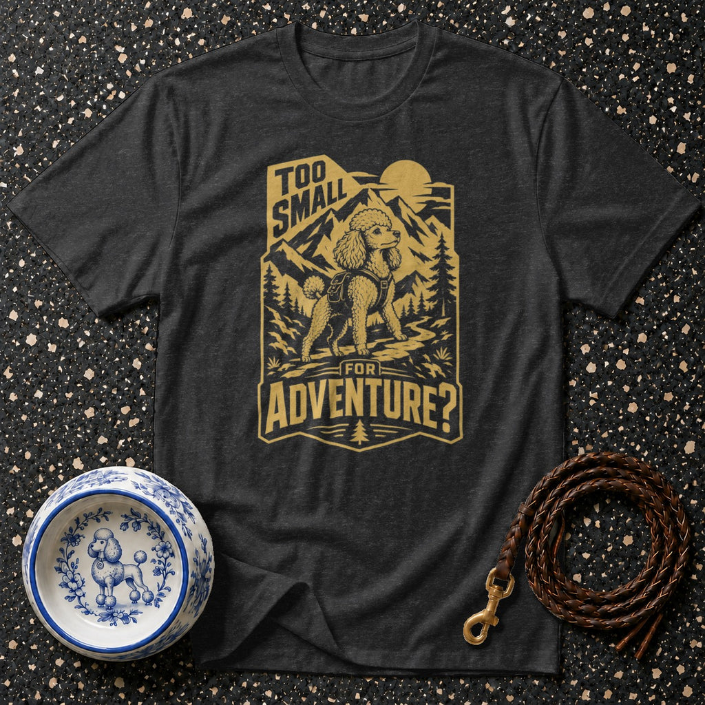 Dark grey t-shirt with a gold graphic of a poodle on a mountain path, text "Too small for adventure?".