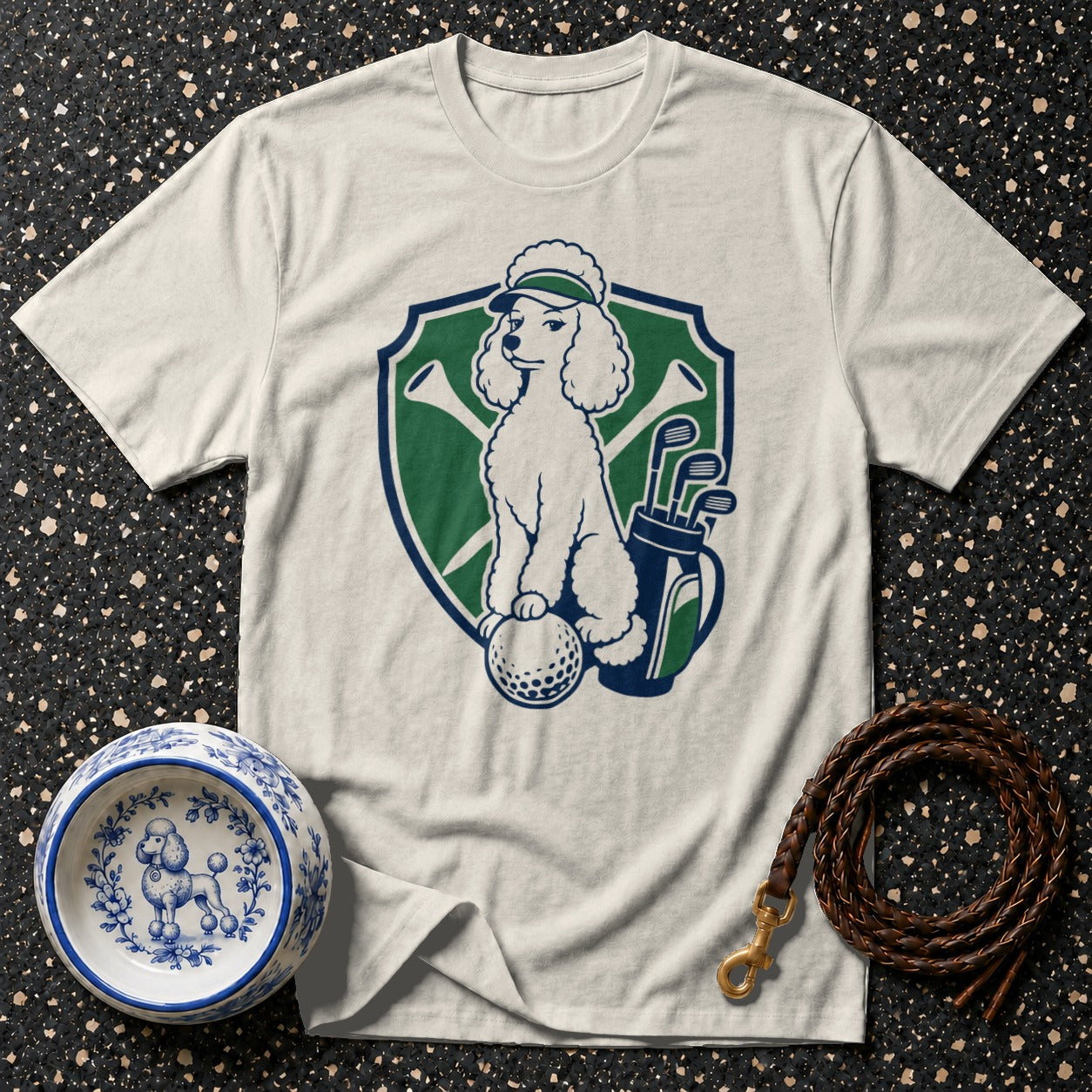 White t-shirt with a graphic of a poodle on a golf ball, holding a golf club.