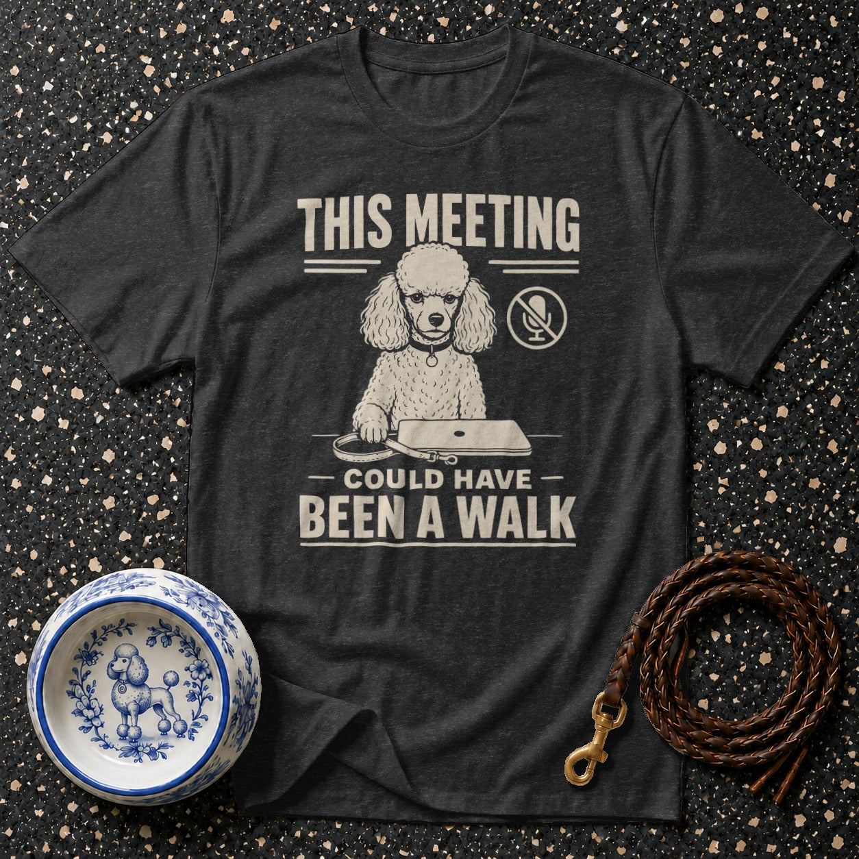 T-shirt with poodle graphic, text "THIS MEETING COULD HAVE BEEN A WALK", dog bowl, and leash.