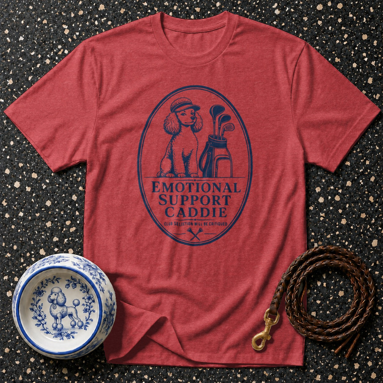 Red t-shirt with graphic of a poodle in a hat and golf clubs, text reads "Emotional Support Caddie".