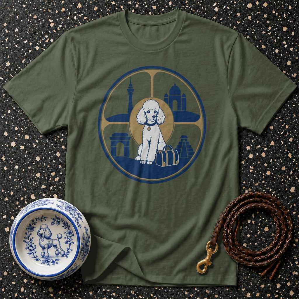 Olive t-shirt with a graphic of a white poodle sitting next to a suitcase within a circular emblem featuring landmarks.