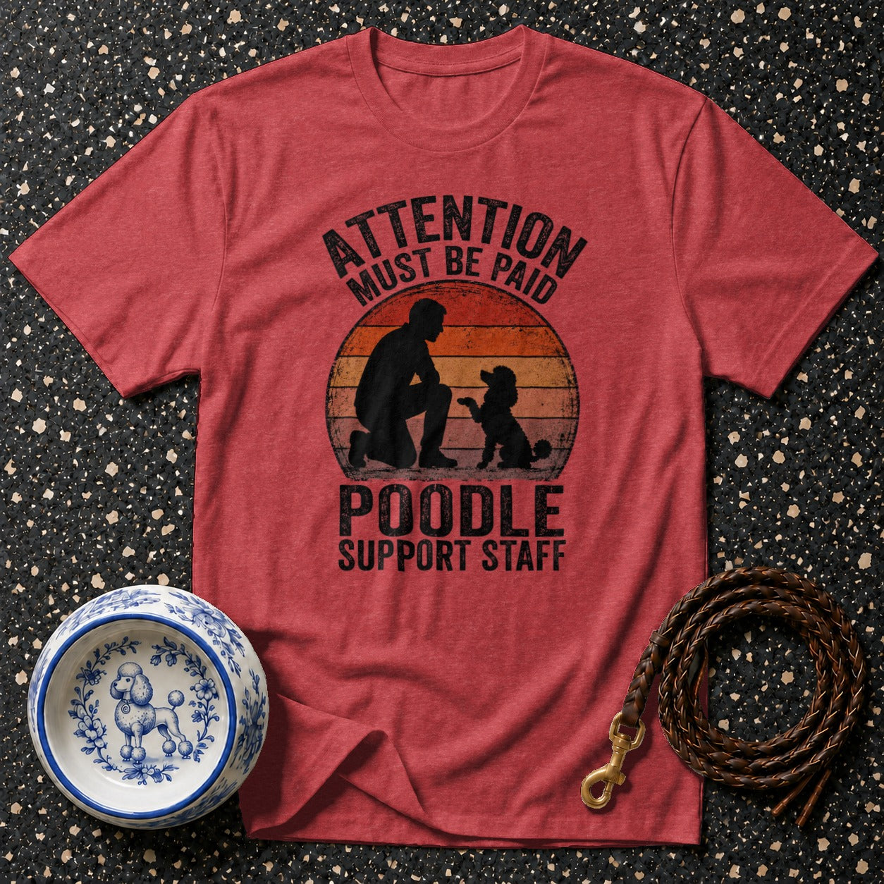 Red t-shirt with "ATTENTION MUST BE PAID POODLE SUPPORT STAFF" graphic.