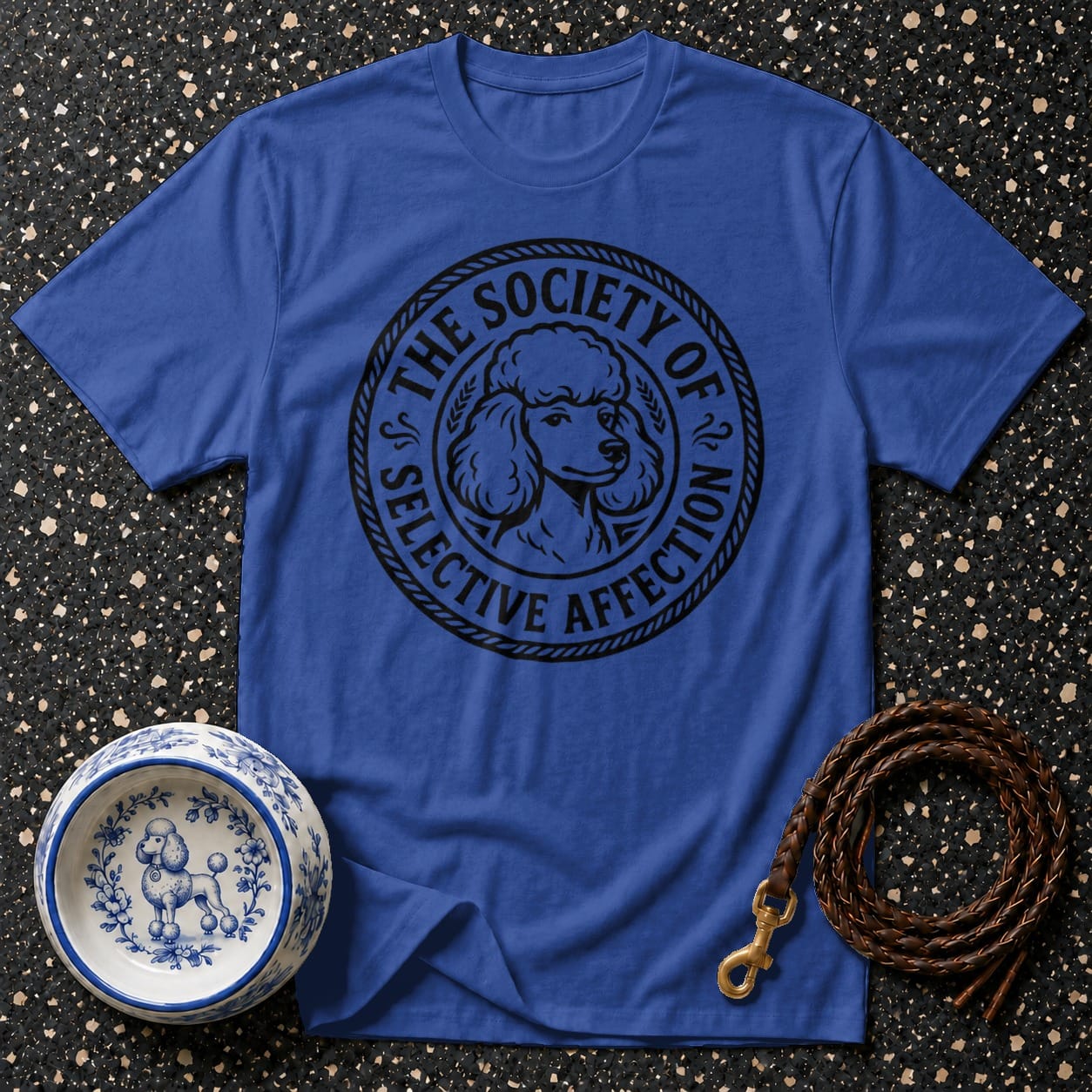 Blue t-shirt with a circular black graphic of a poodle and text reading "The Society of Selective Affection".