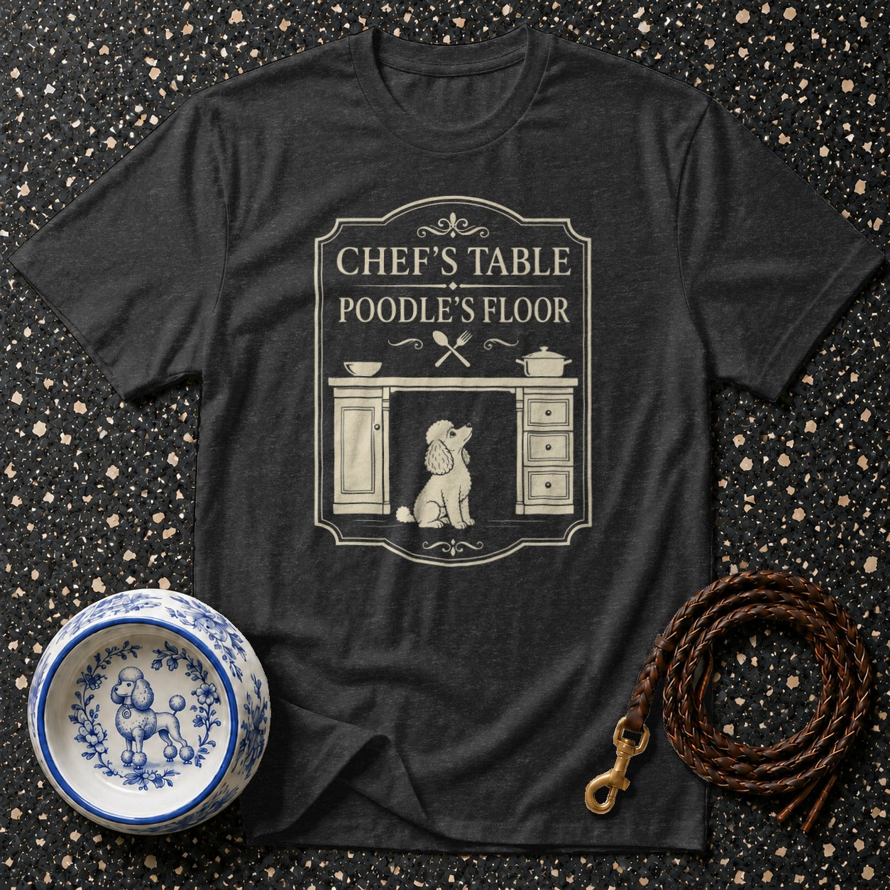 Dark t-shirt with text "Chef's Table Poodle's Floor" and a poodle graphic.