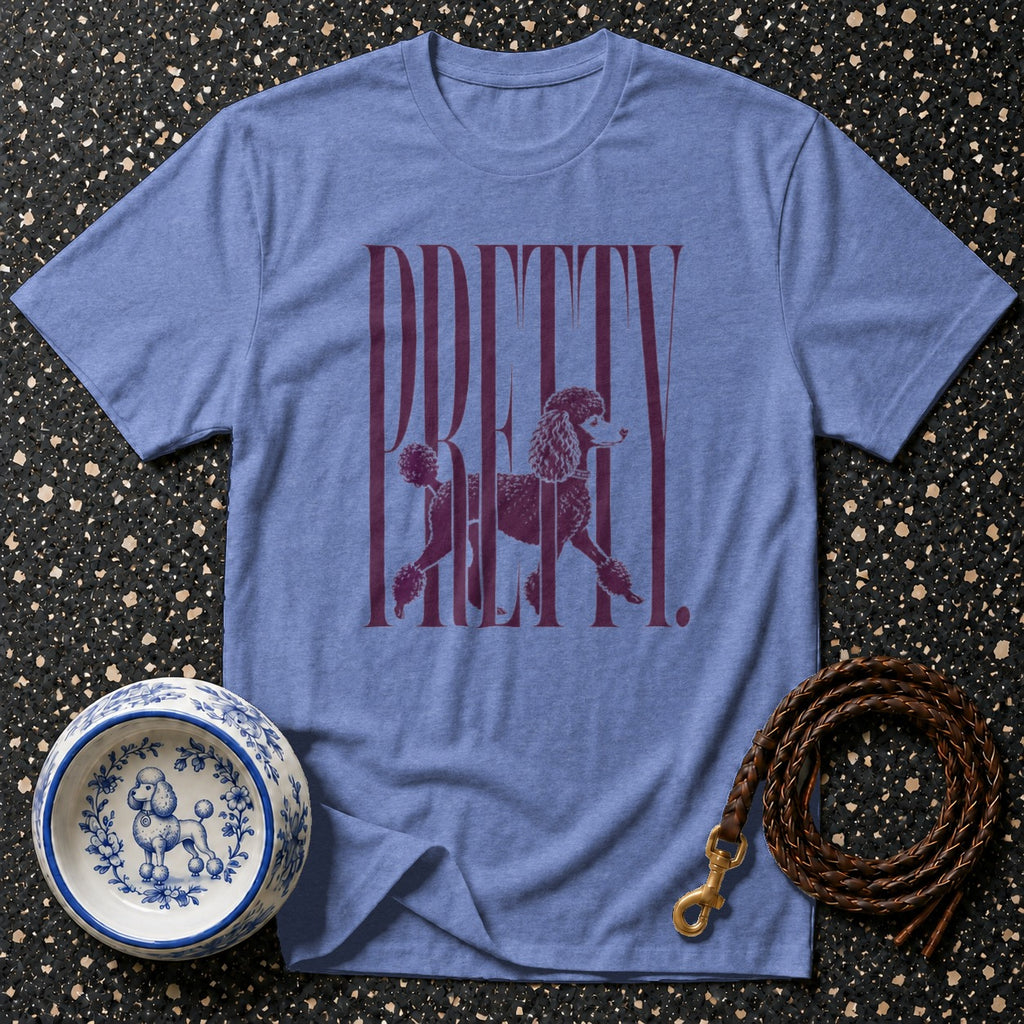 Blue t-shirt with "PRETTY" and poodle graphic, dog bowl, and leather leash.
