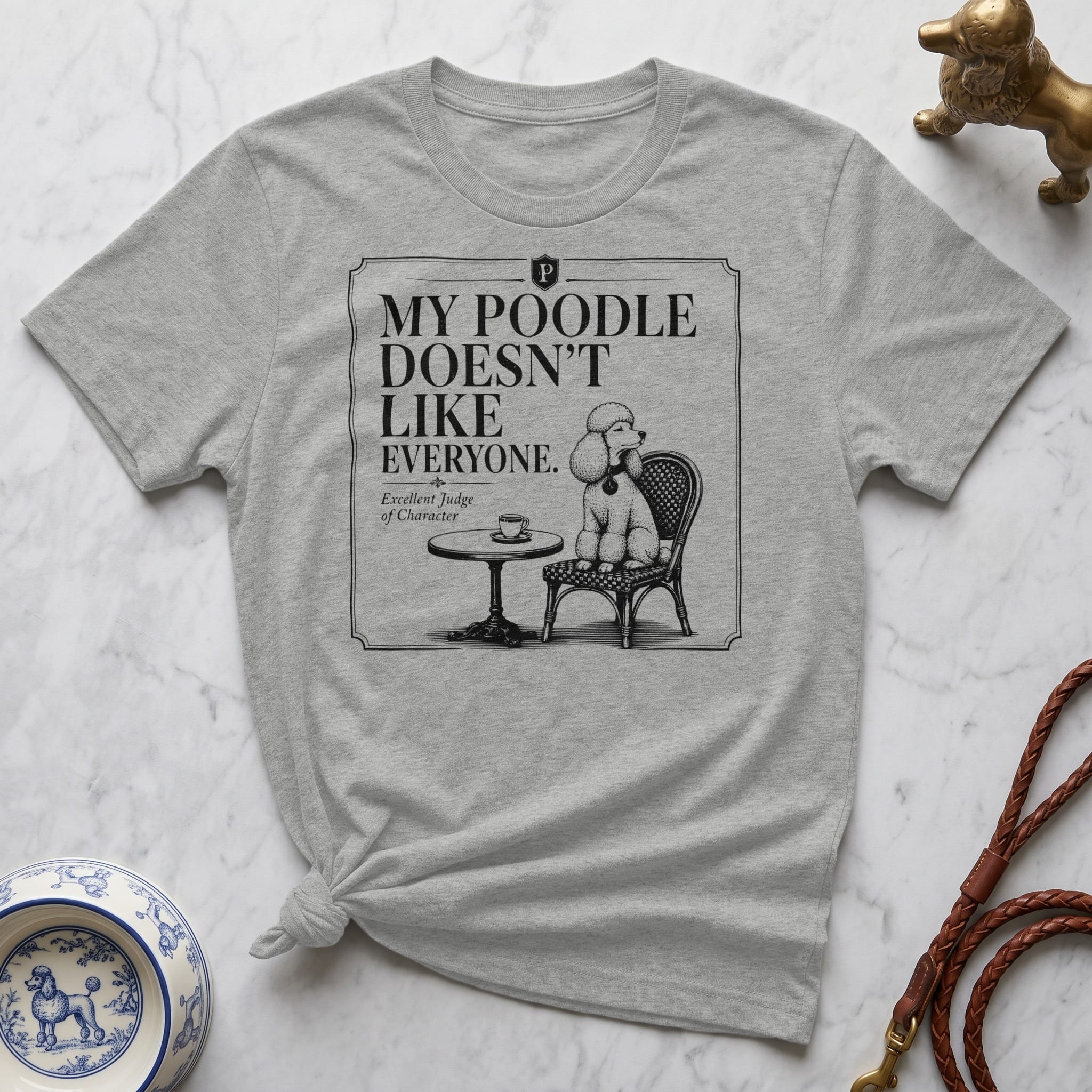 Grey t-shirt with a poodle sitting at a table and text.