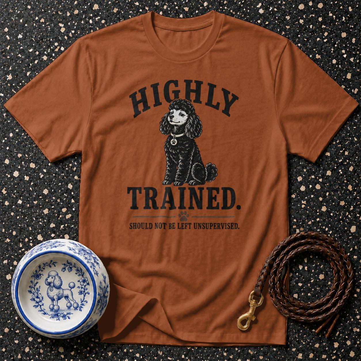 Brown t-shirt with poodle graphic and text: "HIGHLY TRAINED."