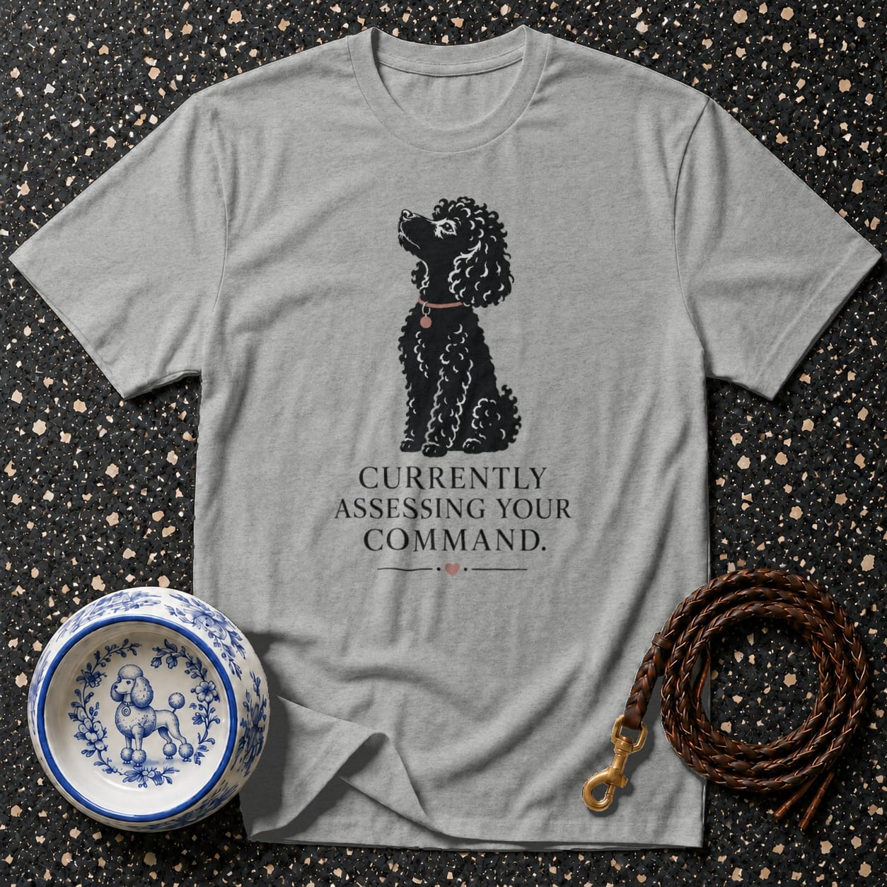 Grey t-shirt with black poodle graphic and text "Currently Assessing Your Command."
