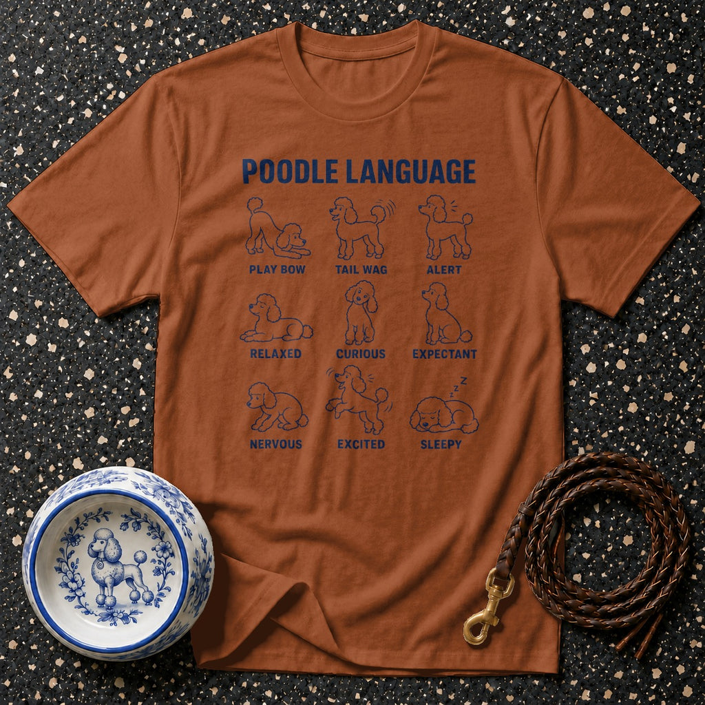 Brown t-shirt with "Poodle Language" text and nine illustrations of poodles displaying different postures and emotions.