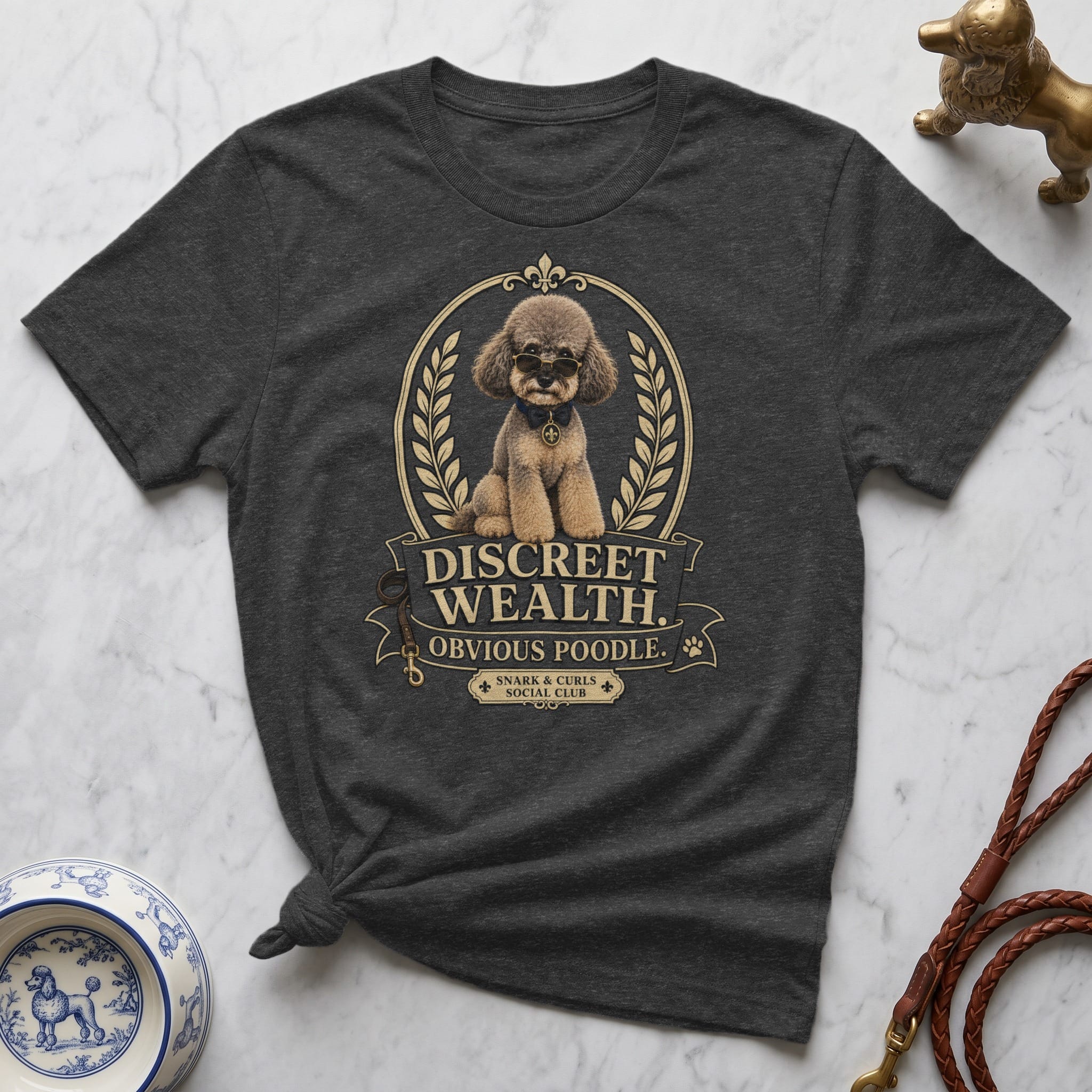 T-shirt with a poodle wearing glasses and a medallion, text "DISCREET WEALTH. OBVIOUS POODLE."