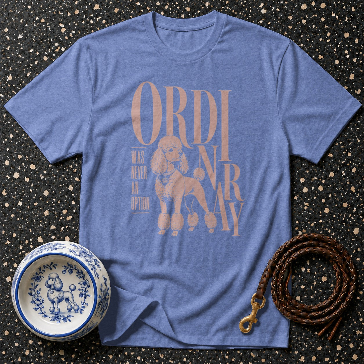 Blue t-shirt with a poodle graphic and text "ORDINARY WAS NEVER AN OPTION".