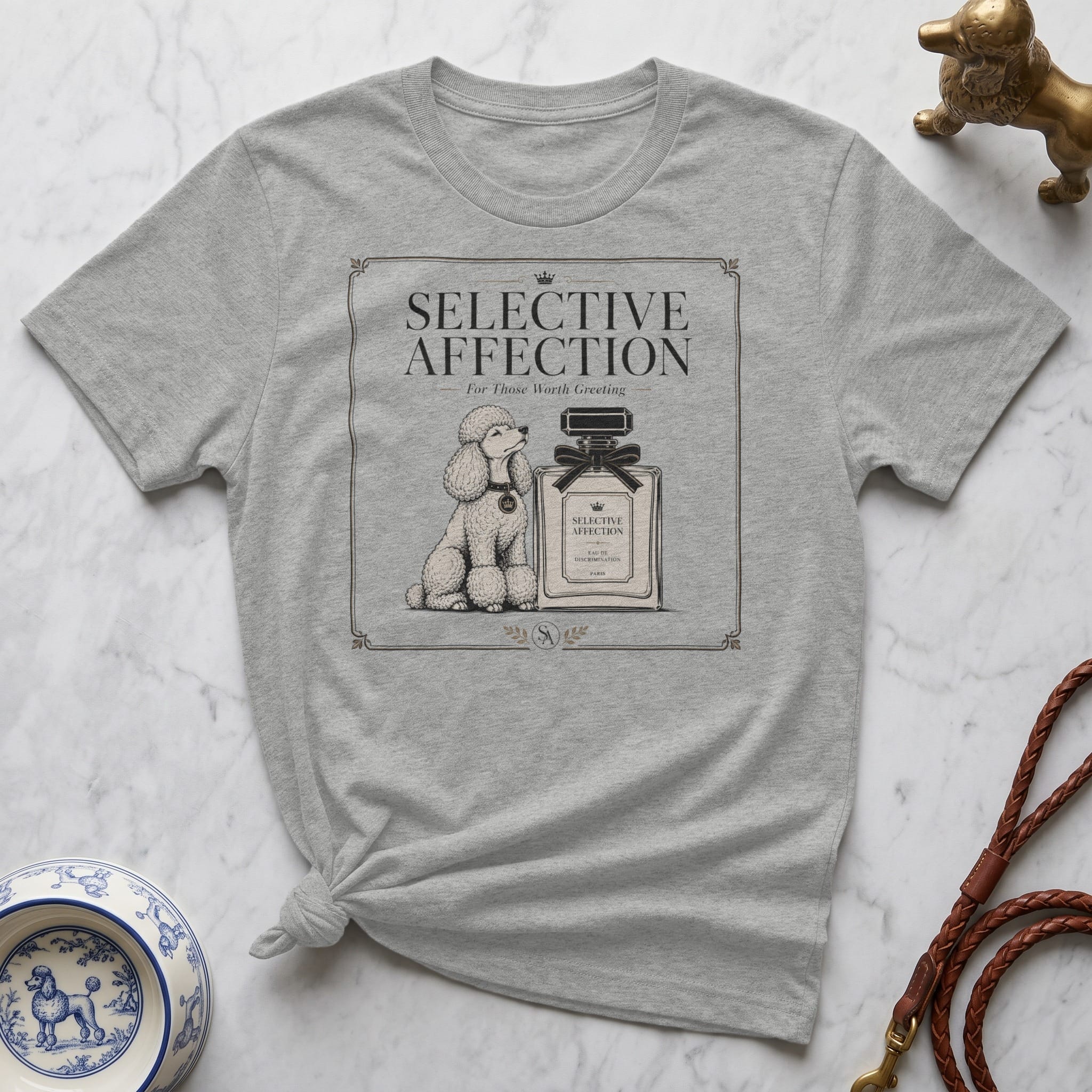 Grey t-shirt featuring a stylized poodle and perfume bottle with "SELECTIVE AFFECTION" text.
