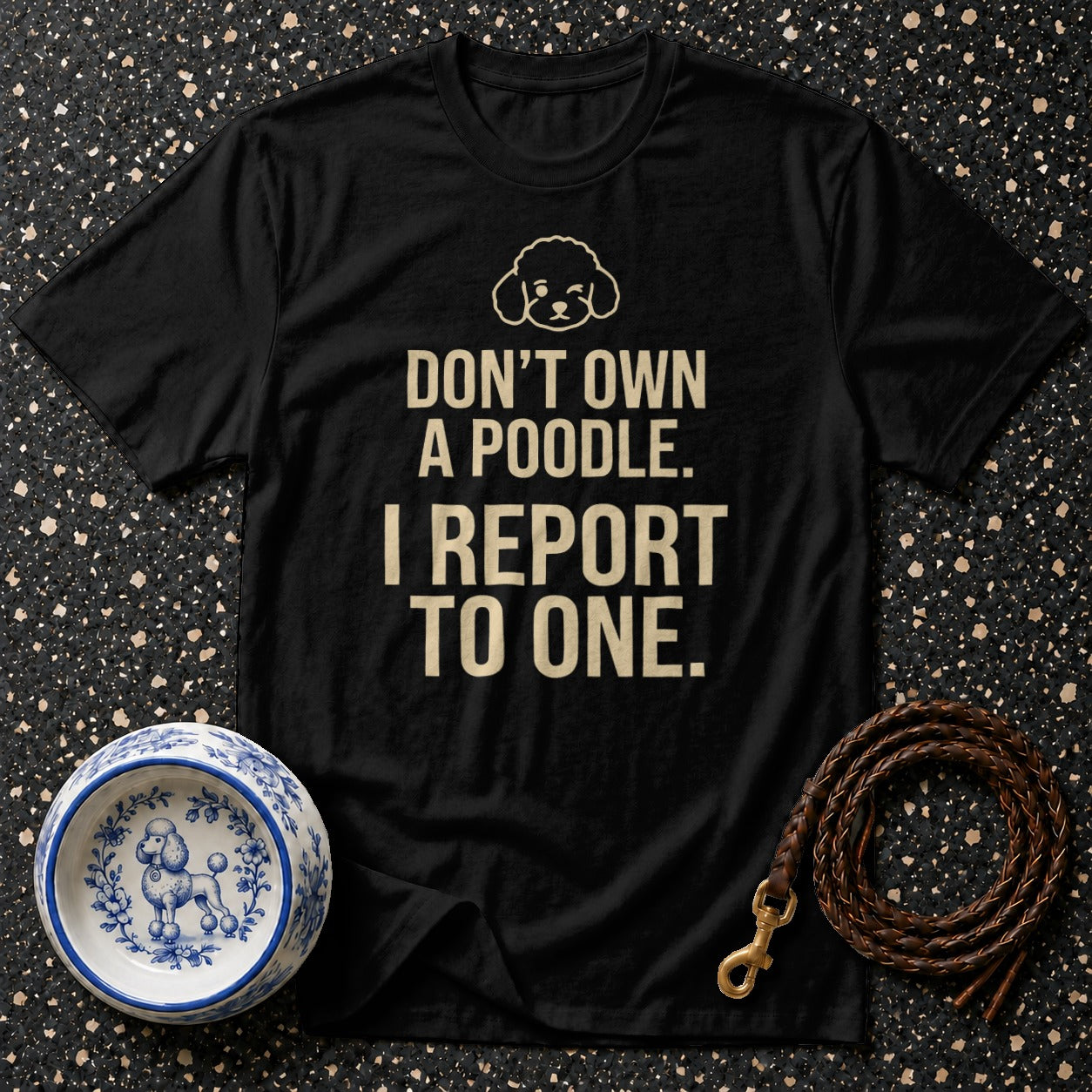 Black t-shirt with text "DON'T OWN A POODLE. I REPORT TO ONE." and poodle graphic.