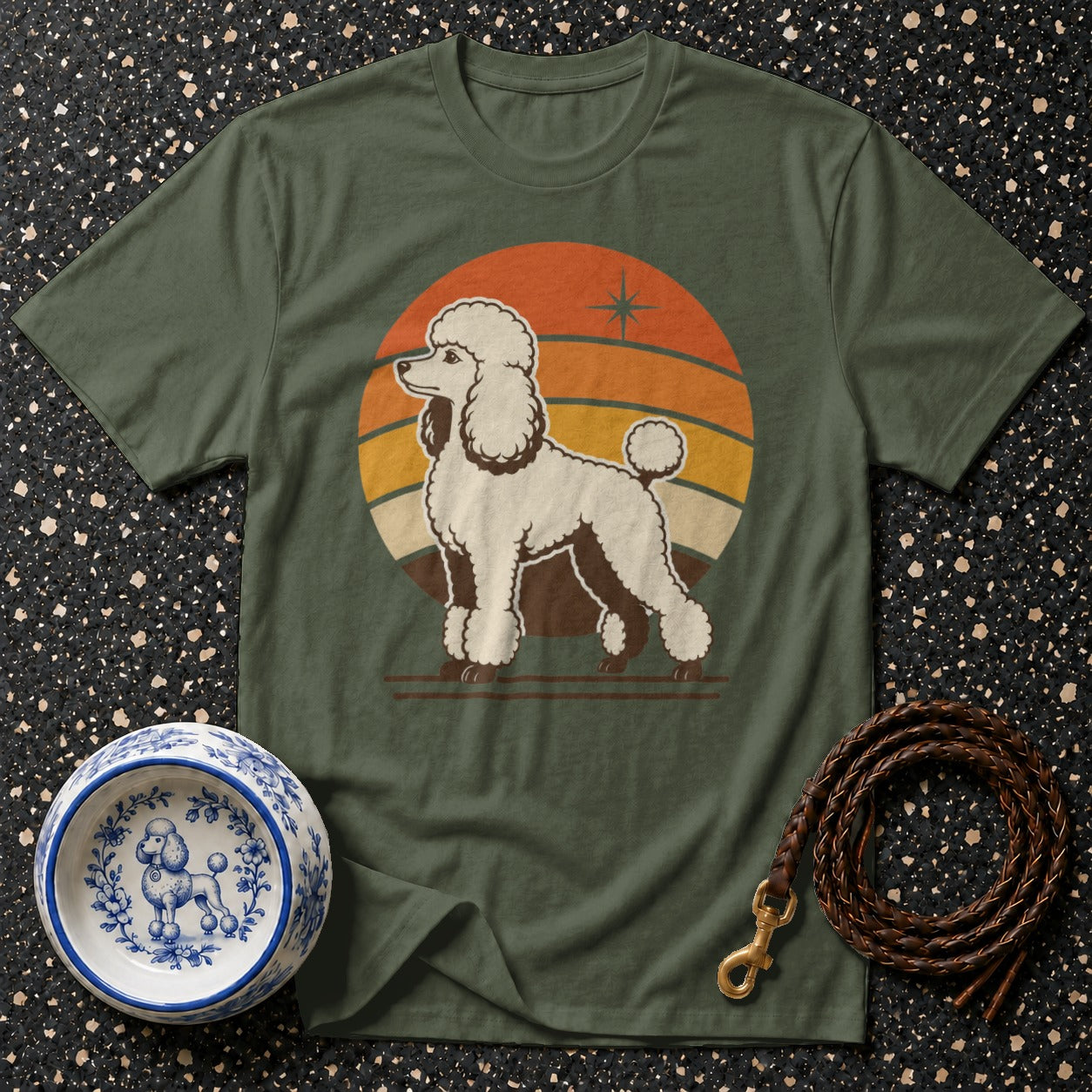 Green t-shirt with a retro poodle graphic and a braided leather dog leash.