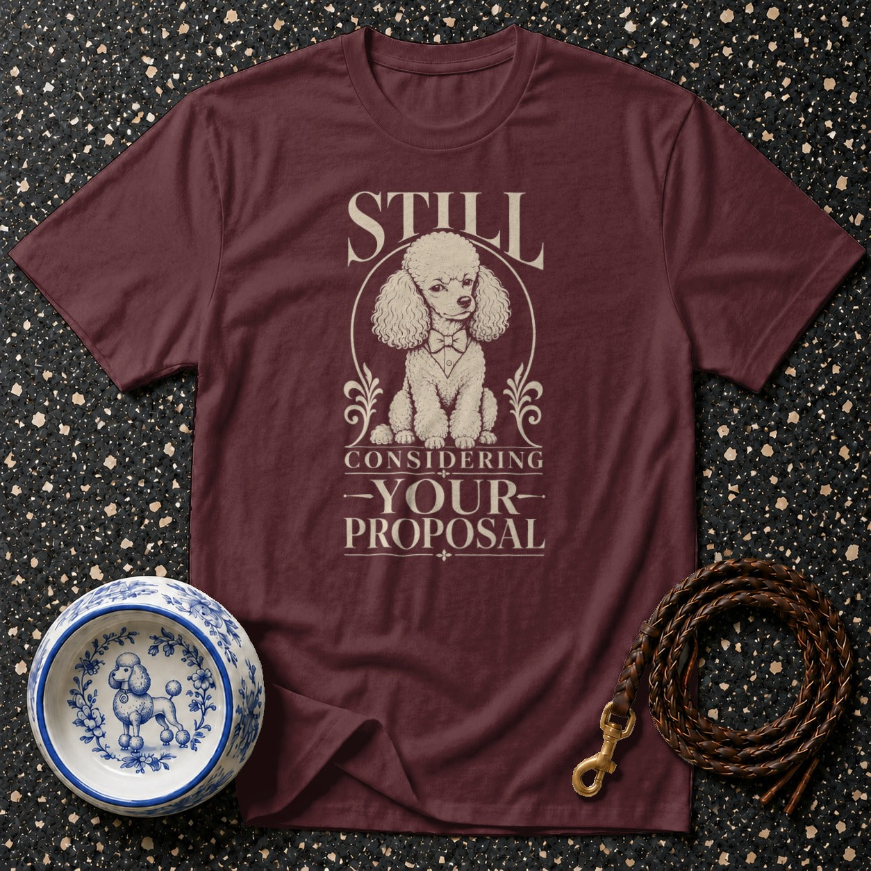 Maroon t-shirt with poodle graphic and text "STILL CONSIDERING -YOUR- PROPOSAL".