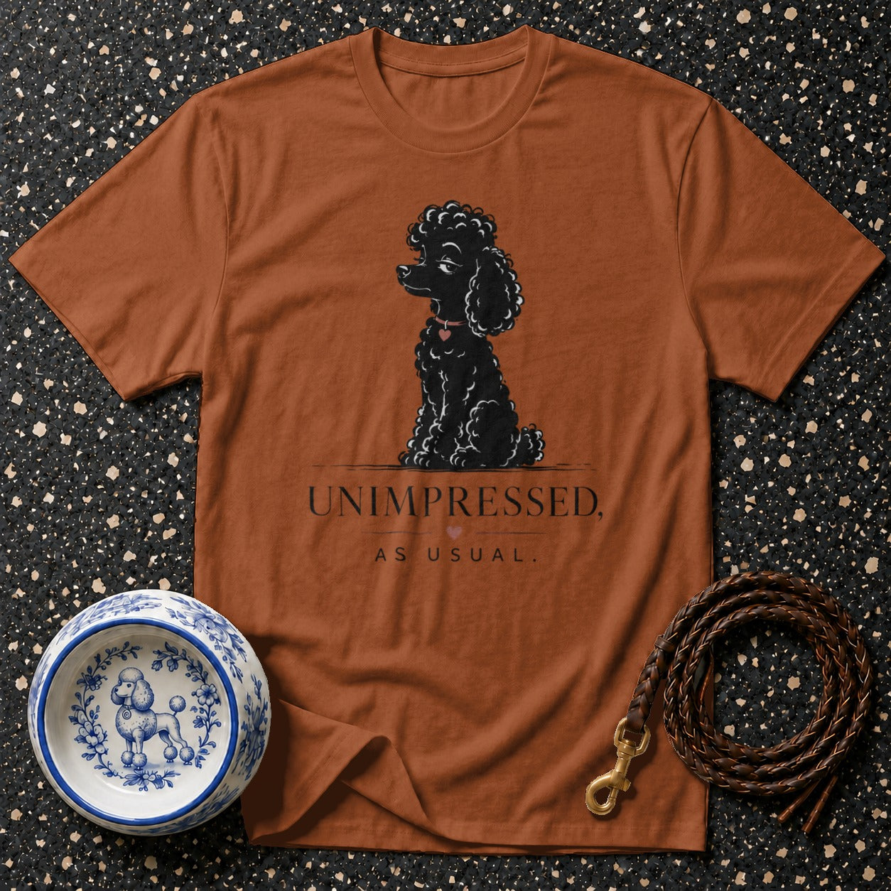 T-shirt with black poodle graphic and text "UNIMPRESSED, AS USUAL."