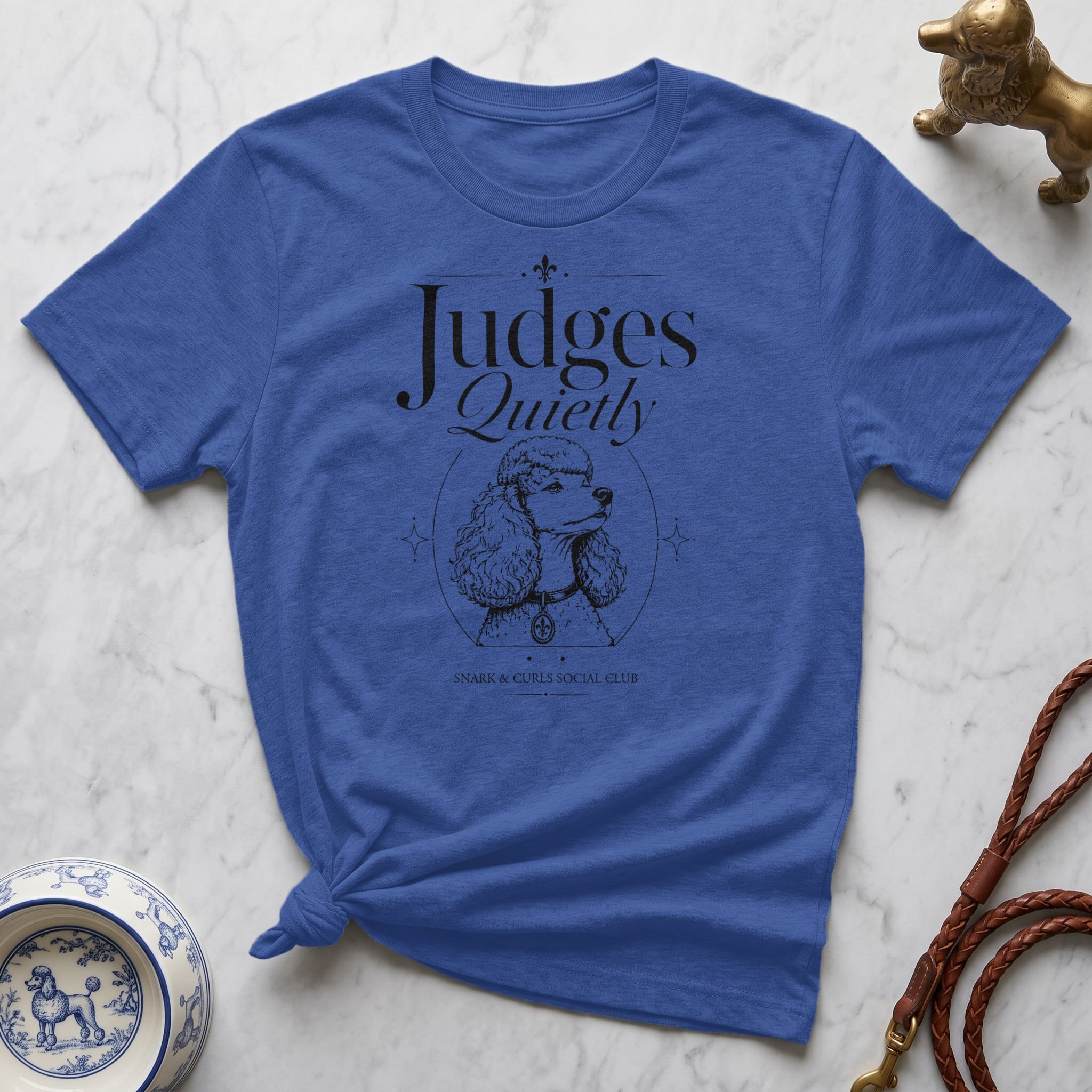 Blue t-shirt with "Judges Quietly" text and a poodle illustration.