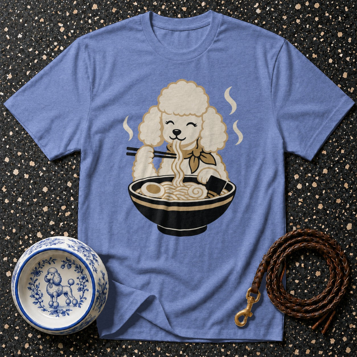 Blue t-shirt with cartoon poodle eating ramen noodles from a bowl.
