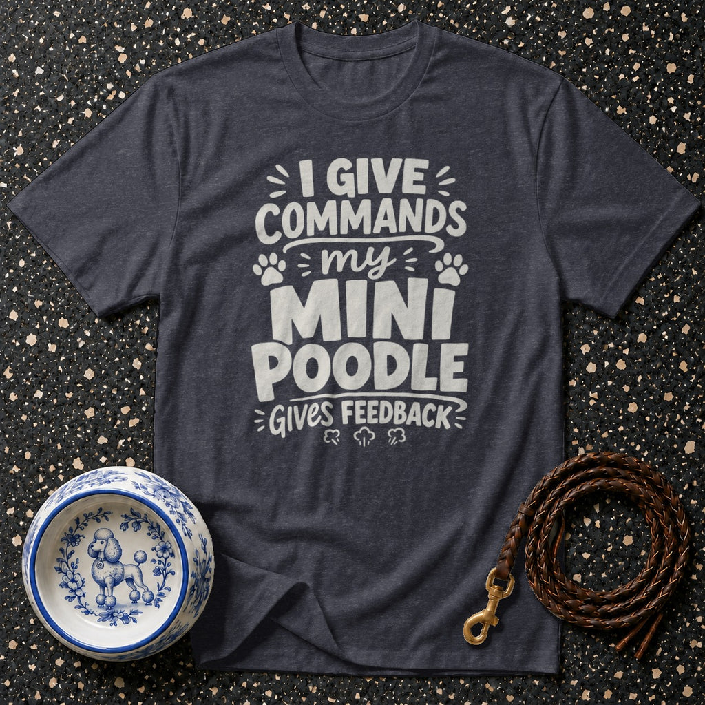 Dark grey t-shirt with white text "I give commands my mini poodle gives feedback".