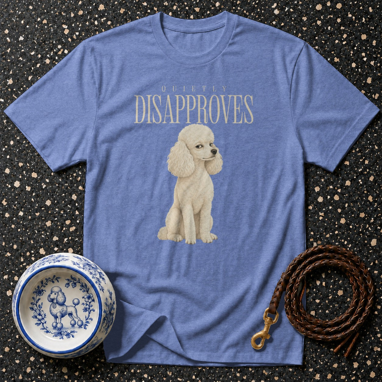 Blue t-shirt with a white poodle and text "QUIETLY DISAPPROVES".