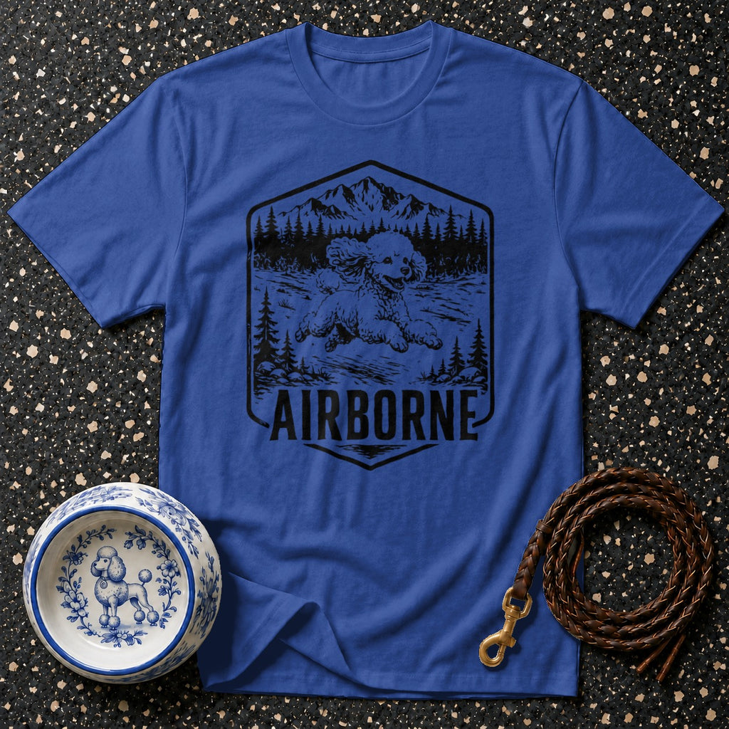 Blue t-shirt with a black graphic of a poodle in a mountain scene with "AIRBORNE" text.