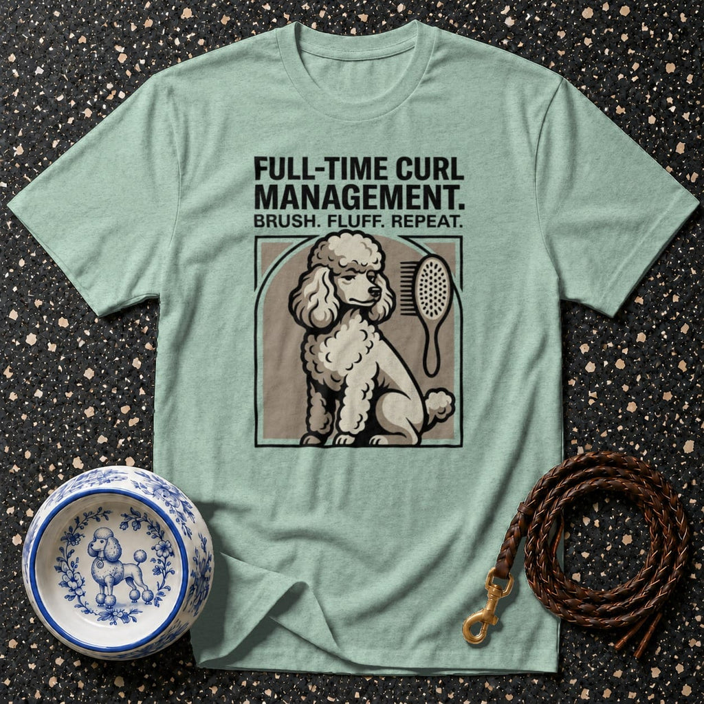 Light green t-shirt with poodle graphic, text and dog grooming accessories.
