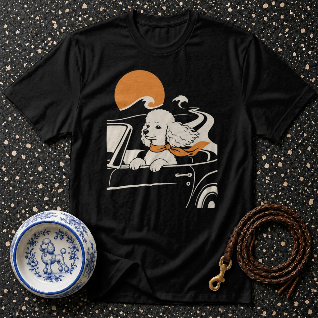 Black t-shirt with poodle driving a car with scarf and orange sun graphic.