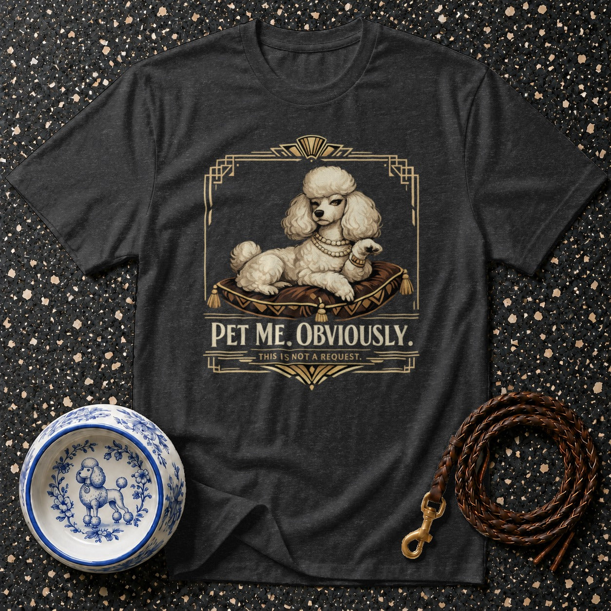 Dark t-shirt with a white poodle on a pillow graphic and text "PET ME. OBVIOUSLY."