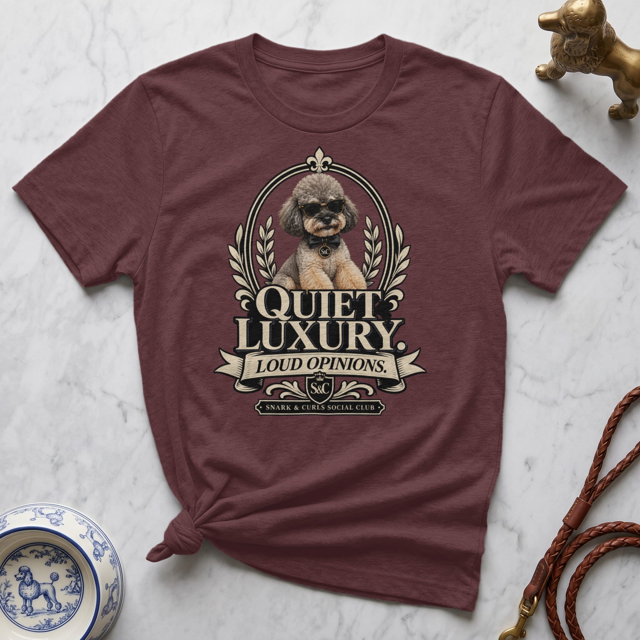 Maroon t-shirt with "Quiet Luxury. Loud Opinions." and dog logo.