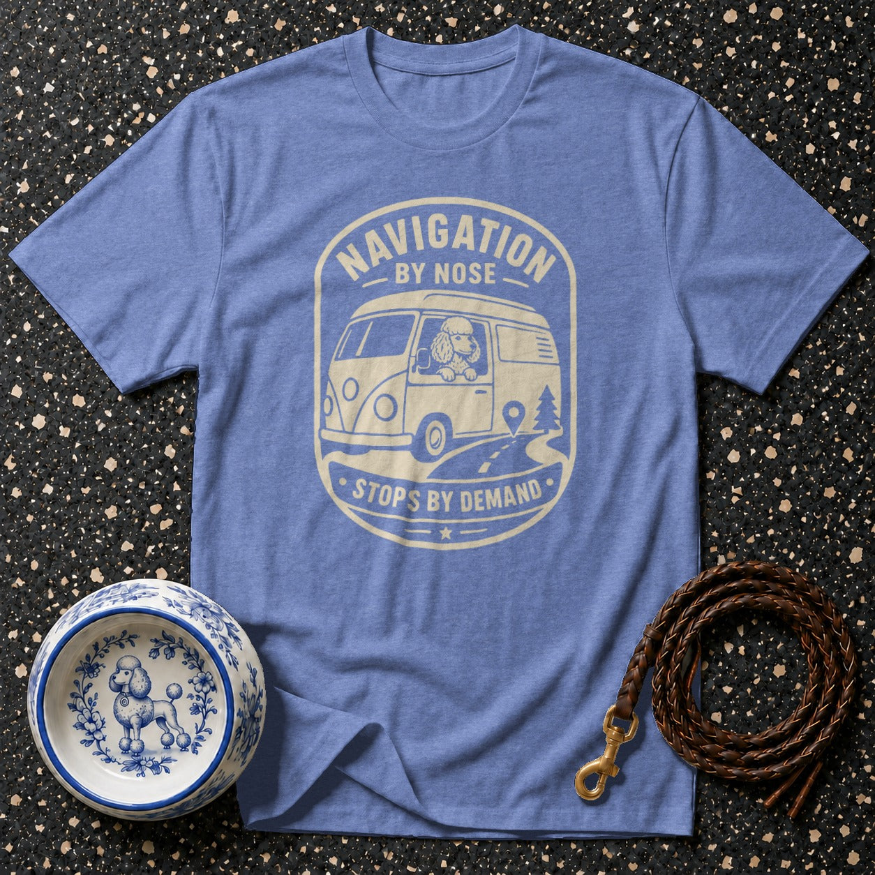 Blue t-shirt with graphic of poodle in van, "Navigation by Nose Stops by Demand".