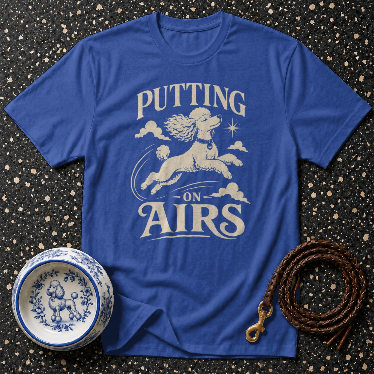 Royal blue t-shirt with a poodle graphic and text "Putting on Airs".