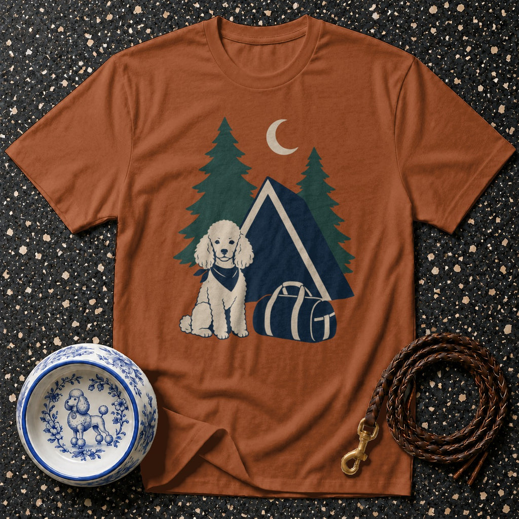 Orange t-shirt with a cartoon poodle, tent, trees, and moon graphic.