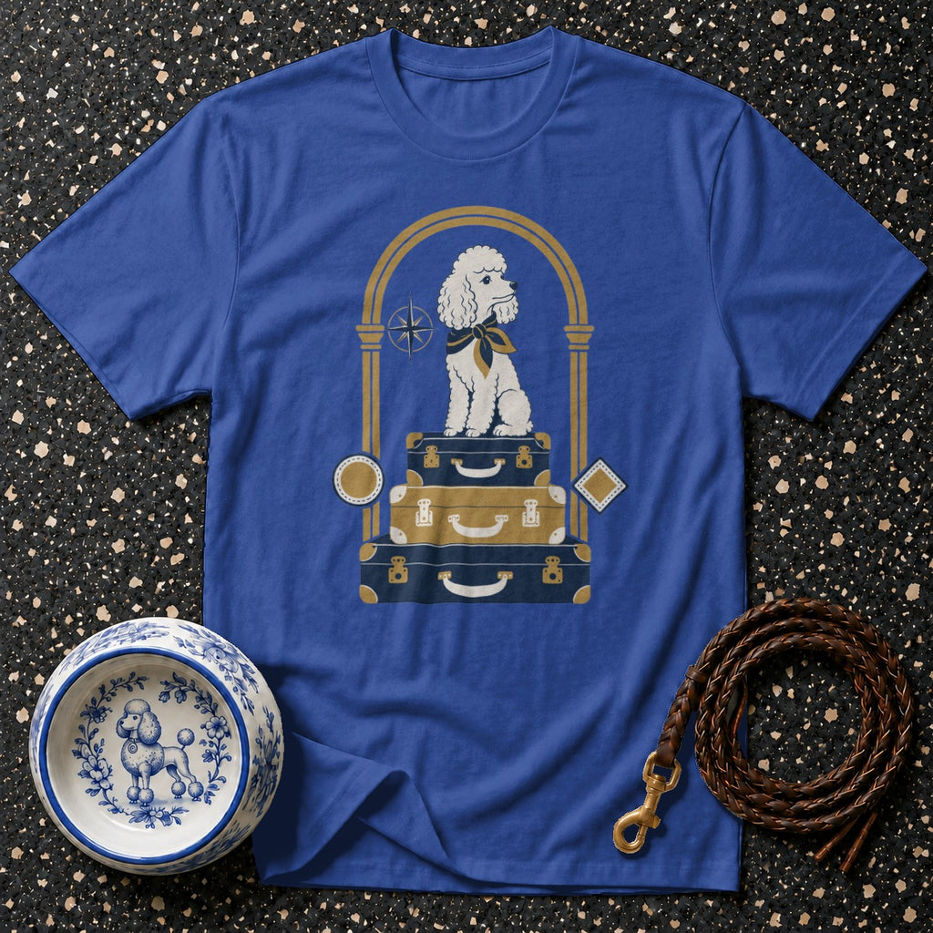Blue t-shirt with illustration of poodle on stacked luggage inside an arch.