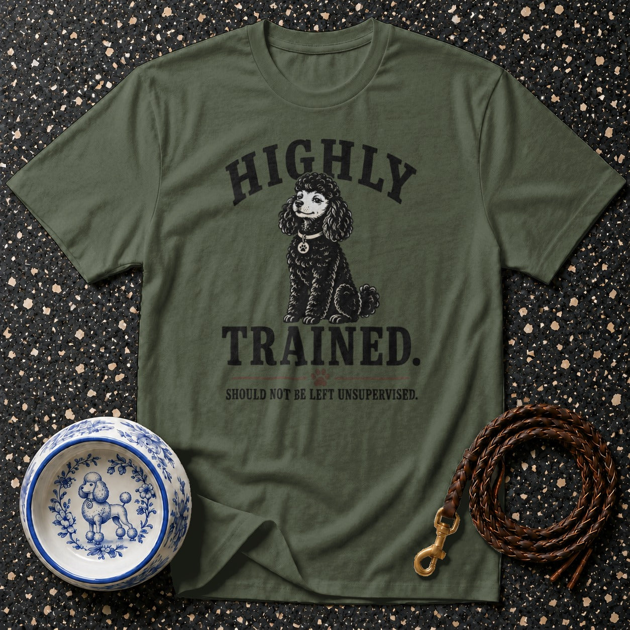 Olive green t-shirt with a black poodle graphic and the text "HIGHLY TRAINED. SHOULD NOT BE LEFT UNSUPERVISED."