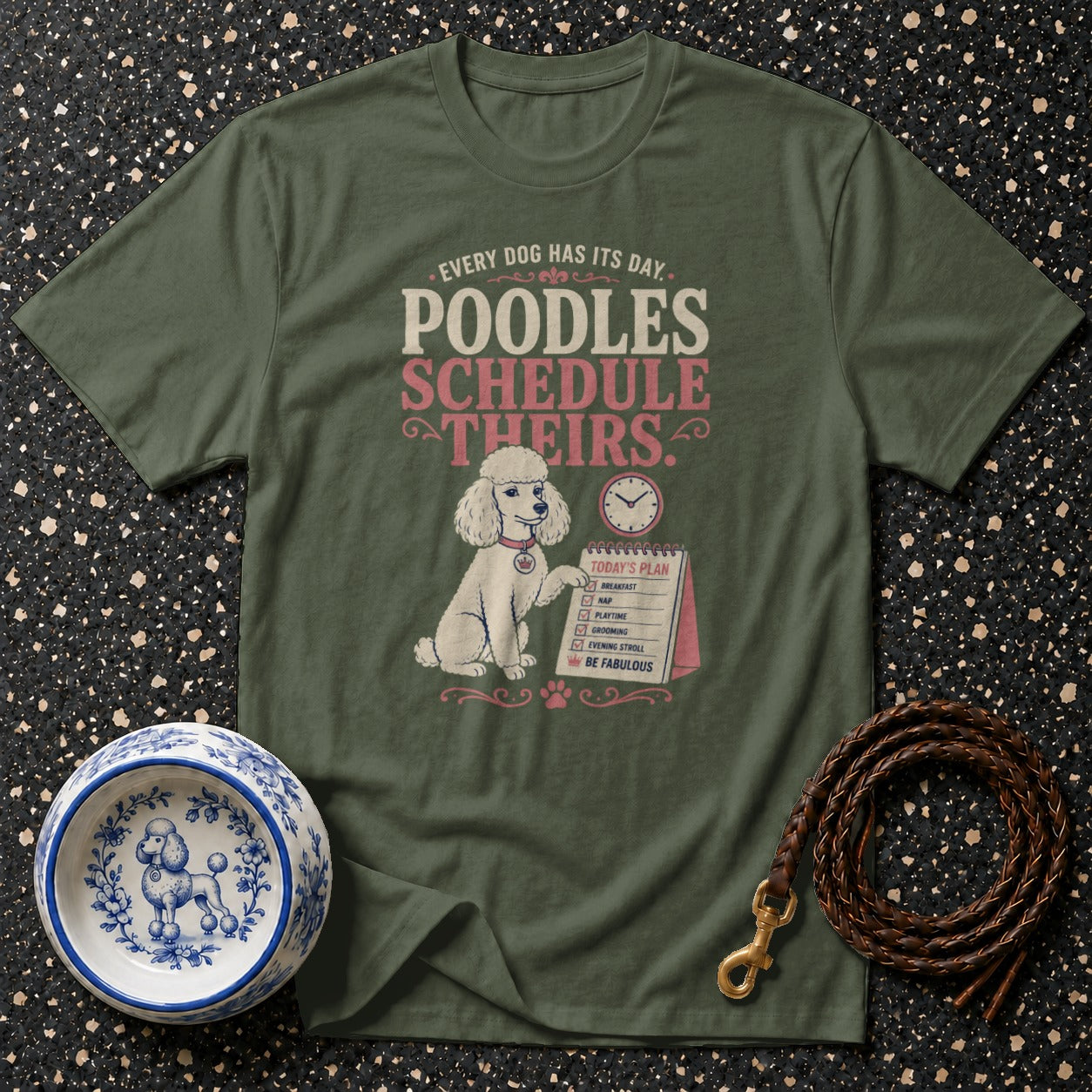 Green t-shirt with poodle schedule graphic and poodle accessories.