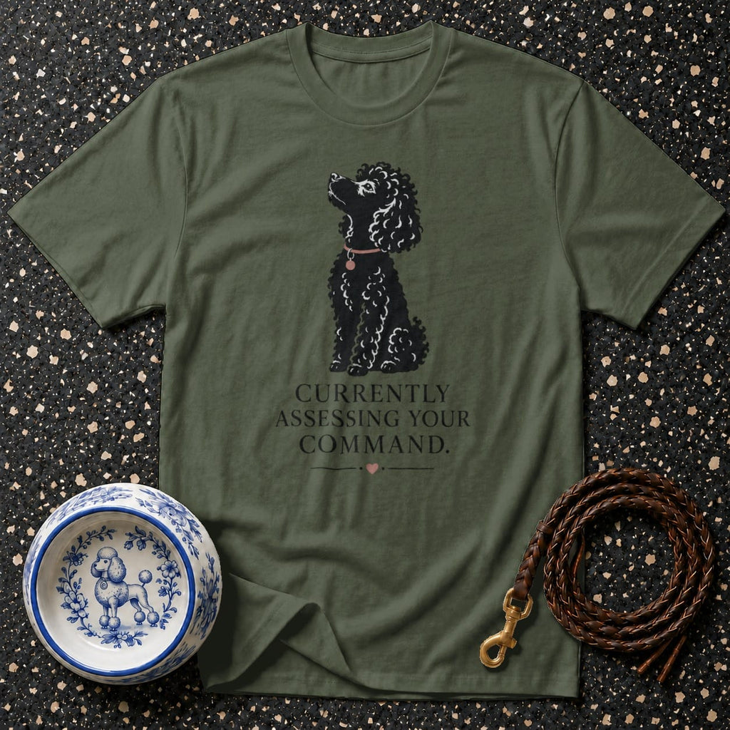 Olive green t-shirt with black poodle graphic and text "Currently Assessing Your Command."